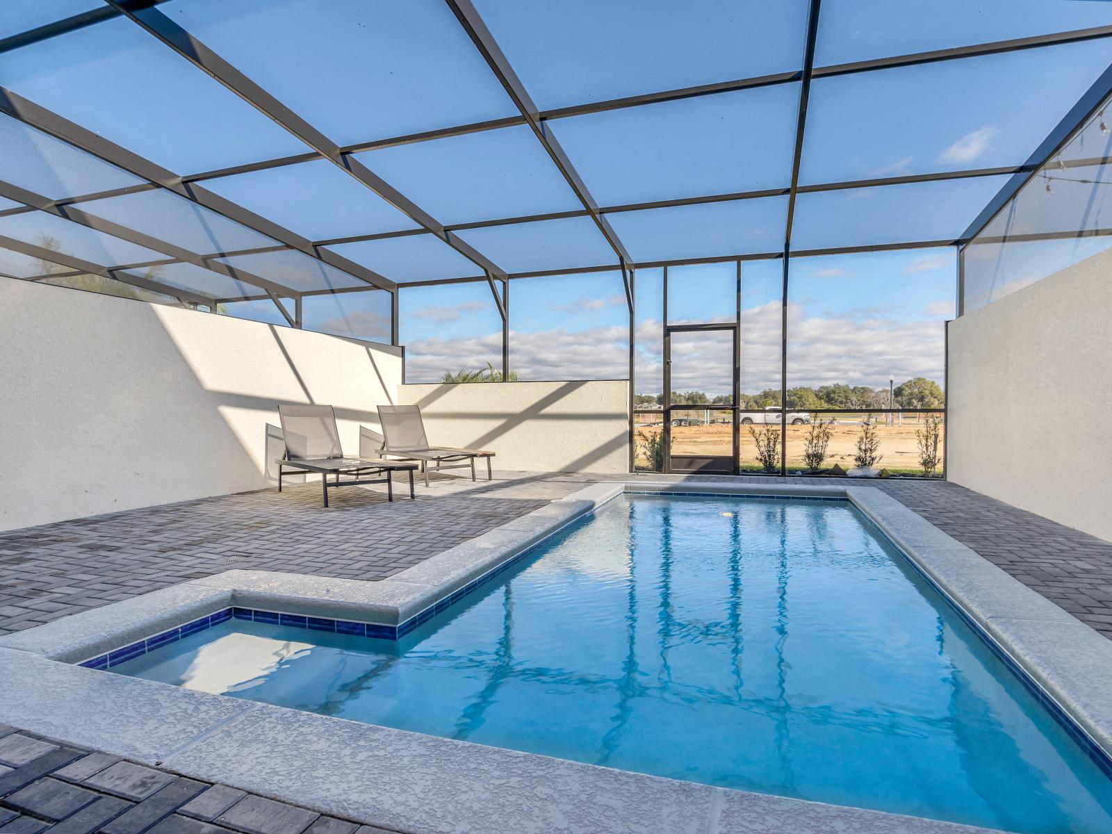 Refreshing private pool of the townhouse in Davenport Florida - Pristine waters reflecting the clear blue sky above - Inviting poolside loungers for basking in the sunshine - A serene escape where you can unwind and rejuvenate in style