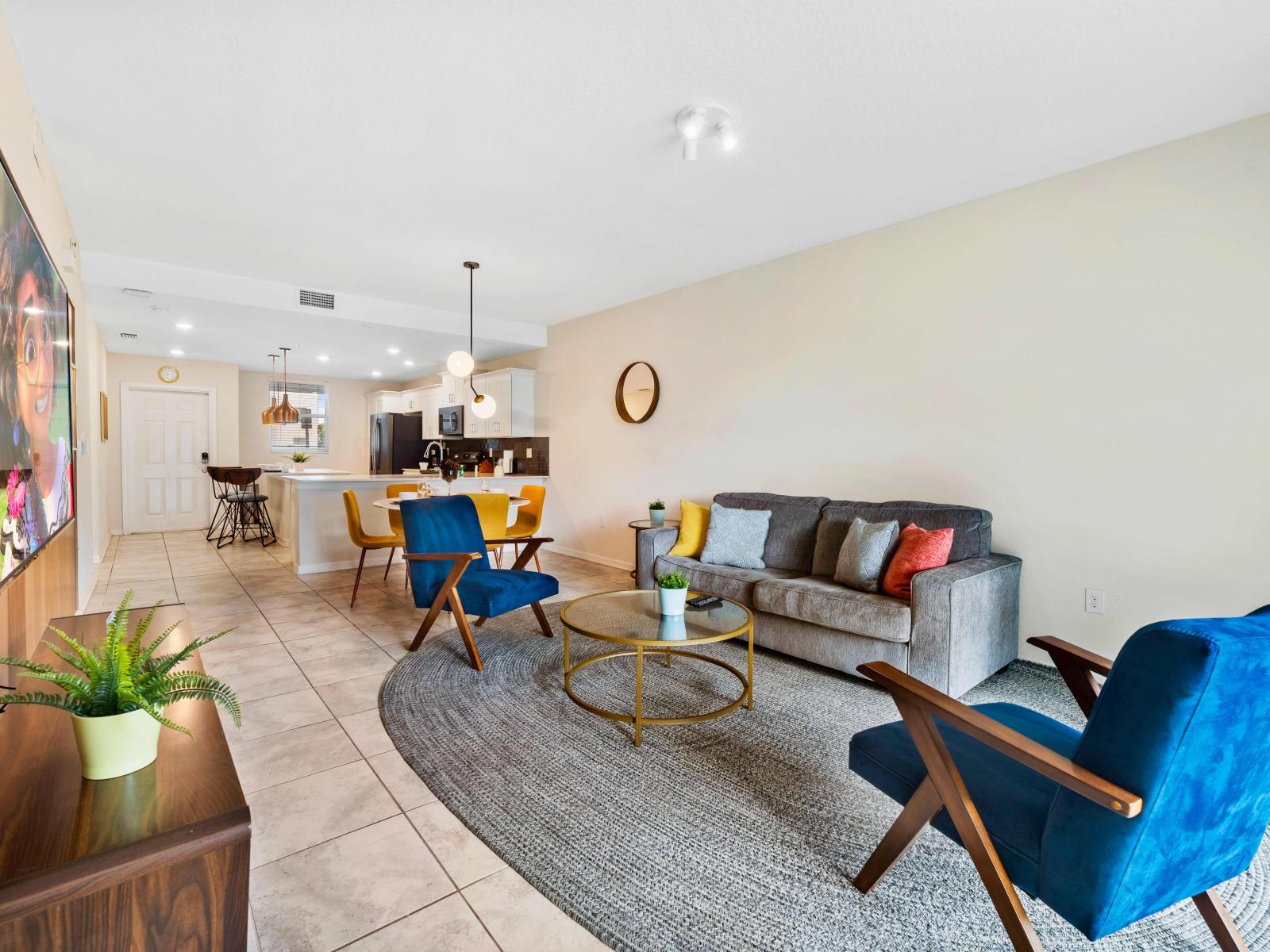 - Alluring Living Area of the Condo in Kissimmee Florida - Harmonious color scheme with pops of accent colors for visual interest - Cozy seating area conducive to relaxation and socializing - Smart TV and Netflix