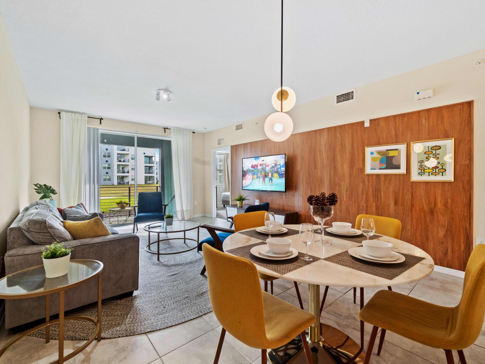 Lush Dining Area of the Condo in Kissimmee Florida - 4 Persons Dining - Open-concept design facilitates seamless flow between living and dining area - Statement lighting fixtures