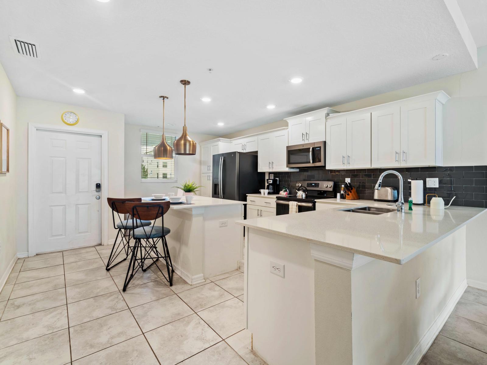 Full equipped kitchen of the Condo in Kissimmee Florida - Plenty of storage space for organized and clutter-free counters - Open concept connecting the kitchen to the dining and living area