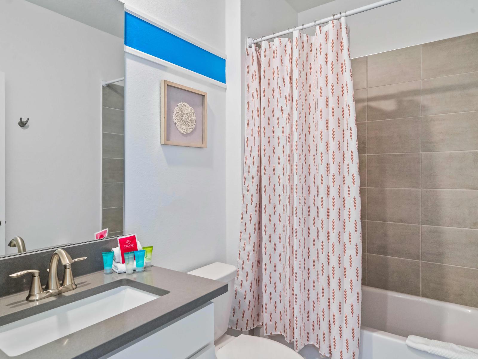 Indulge in a luxurious soak in our spacious bathroom of the home in Kissimmee - Experience the convenience of a bathtub and the functionality of a shower in our versatile bathroom - Admire the exquisite craftsmanship and beauty of stunning vanity