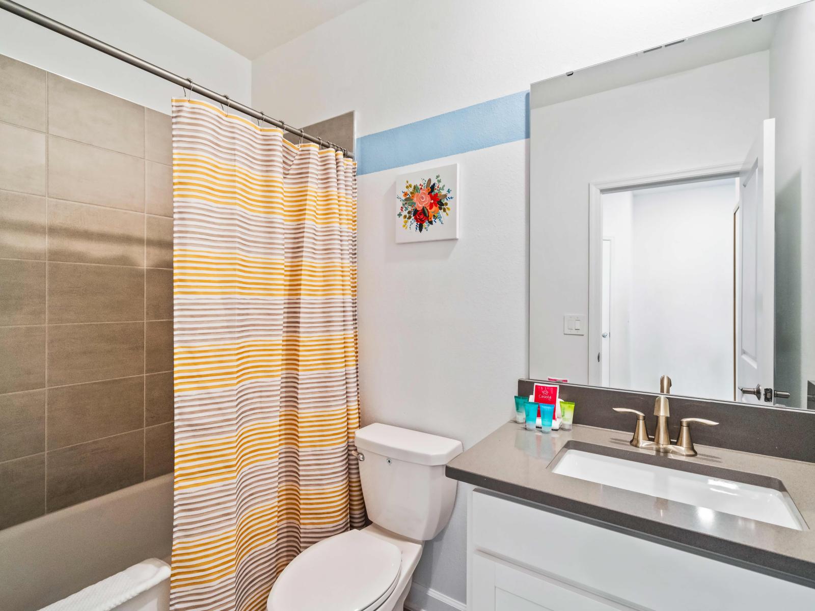 Luxurious Bathing Experience Immerse yourself in relaxation in luxury bathroom of the home in Kissimmee - Enjoy the convenience of a combined bathtub and shower in our modern bathroom - Our bathroom boasts a sleek vanity and neat toilet seat