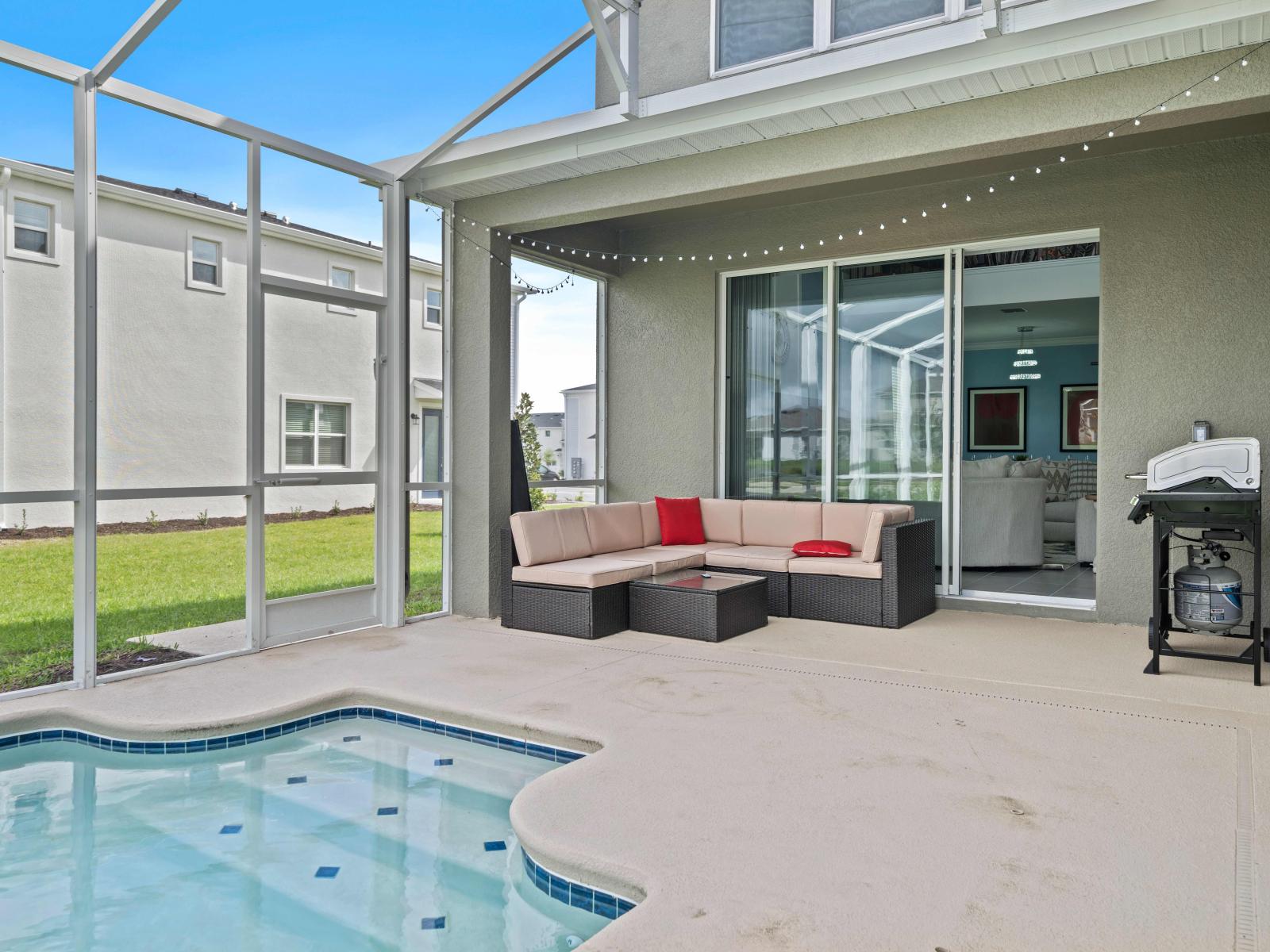 Relax and unwind in our inviting outdoor sitting and pool area of the home in Kissimmee - Offering the perfect spot to soak up the sun and enjoy the poolside ambiance. - Escape the hustle and bustle of everyday life and retreat to our outdoor Sitting