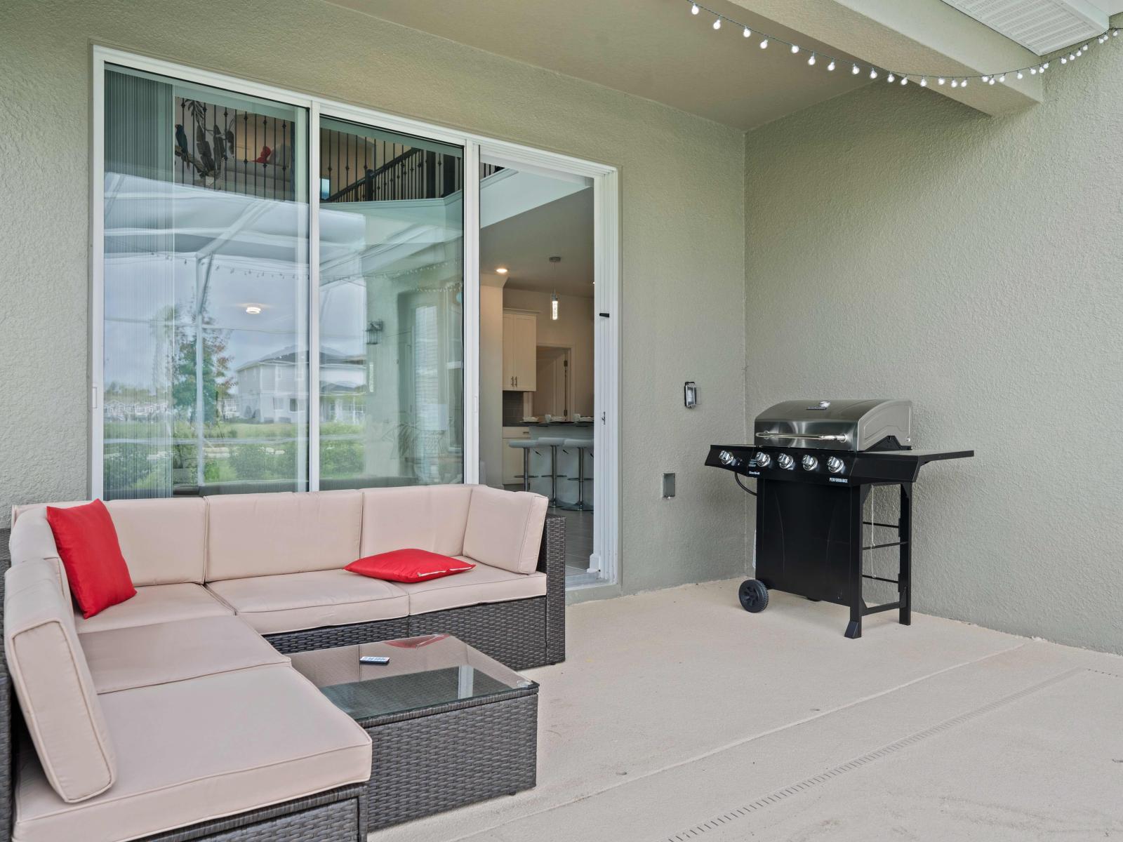 Escape to tranquility in our serene outdoor seating area of the home in Kissimmee - Completed with a BBQ grill for leisurely meals and entertainment - Unleash your culinary skills in our well-equipped outdoor seating area, featuring a BBQ Grill.