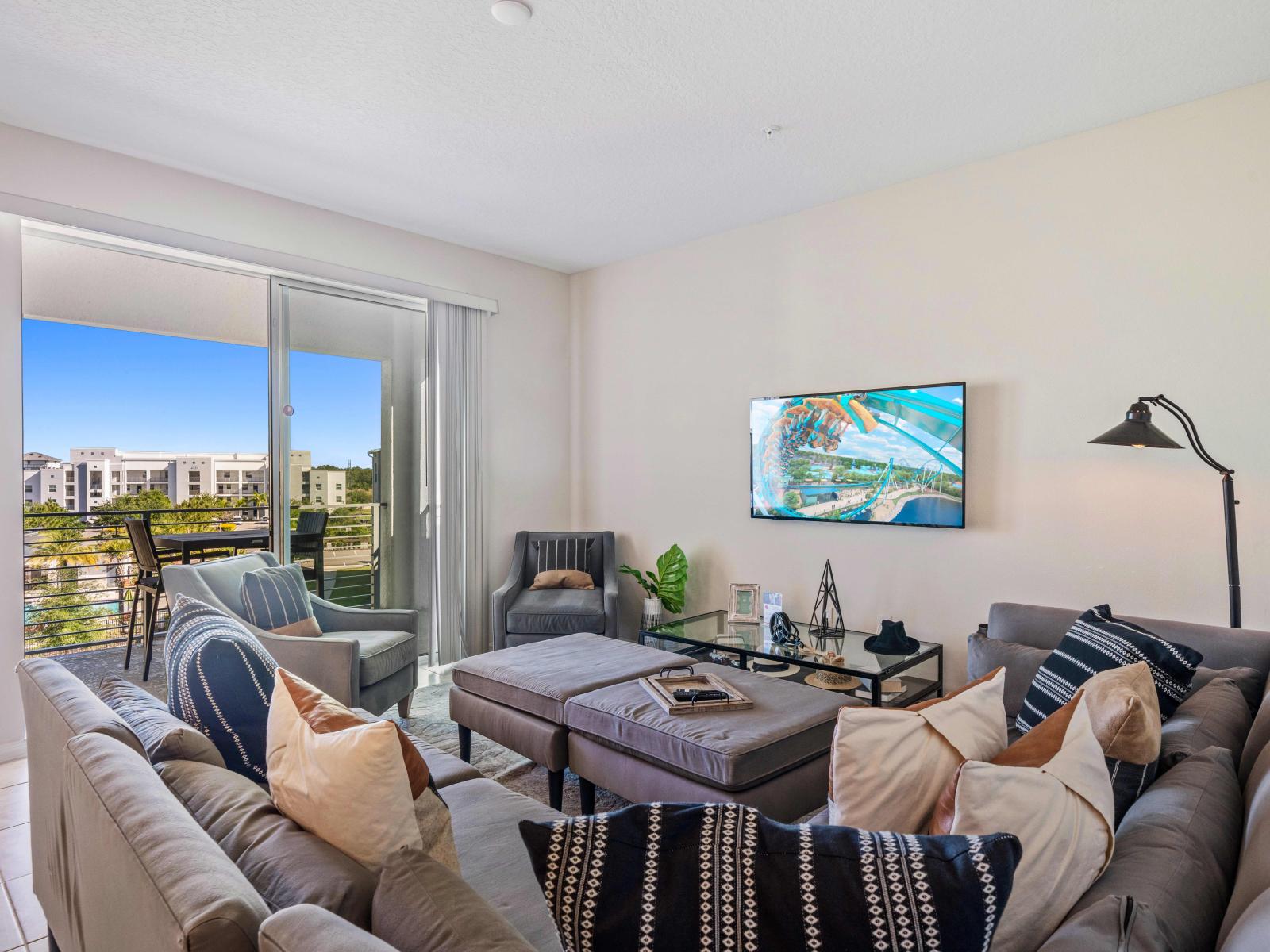 Lavishly Designed Living Area of the Condo in Kissimmee - Stunningly located glass doors that leads to the private balcony - Beautifully arranged cozy sofas to relax - Glorious outside views - Smart TV ad Netflix available