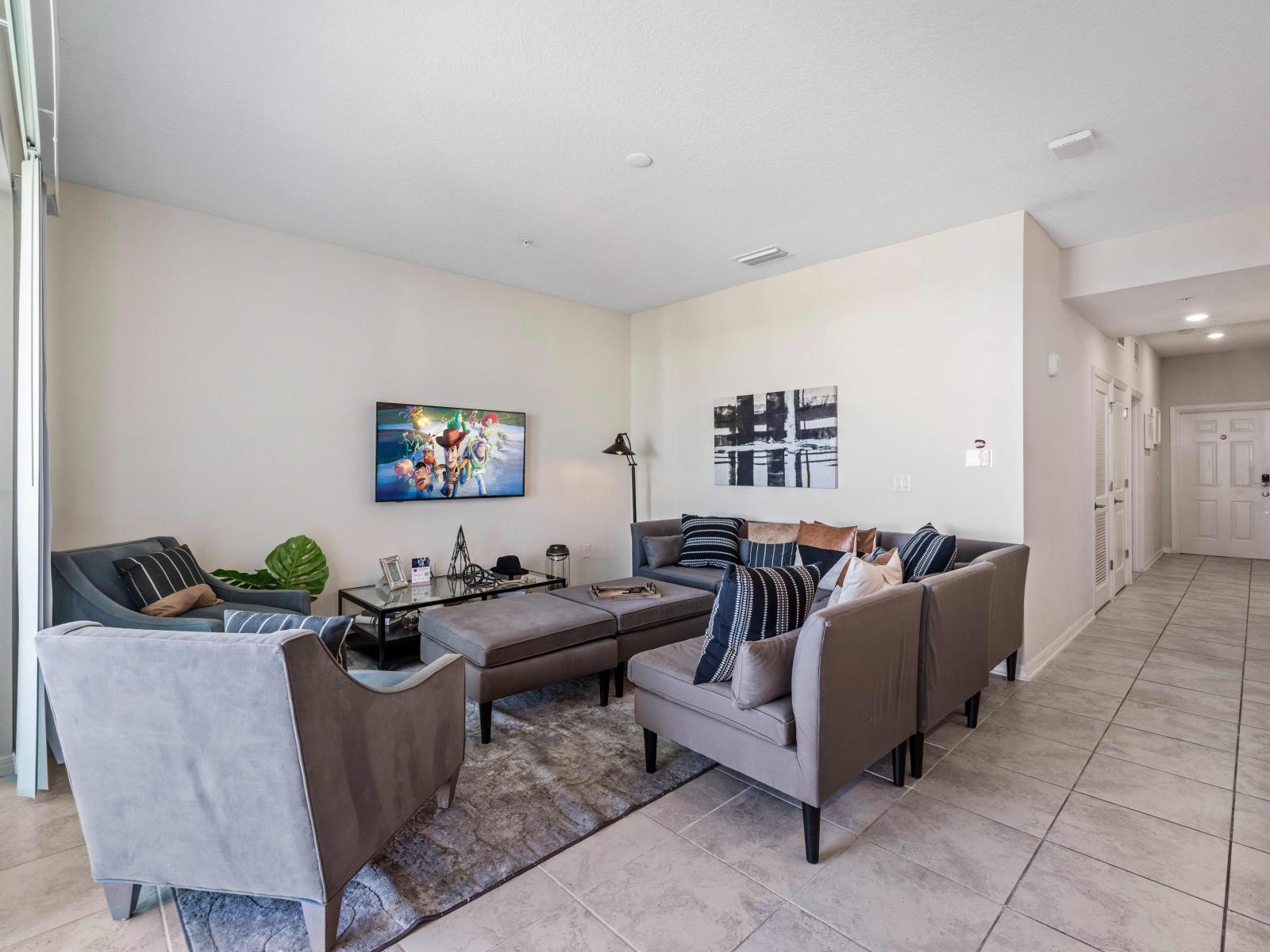 Sublime living area of the Condo in Kissimmee - Cozy sofas elegantly arranged for relaxation - Stunningly decored space - Balcony facing living area of the condo - Availability of Smart Tv and Netflix - Beautiful tile furnished Floor