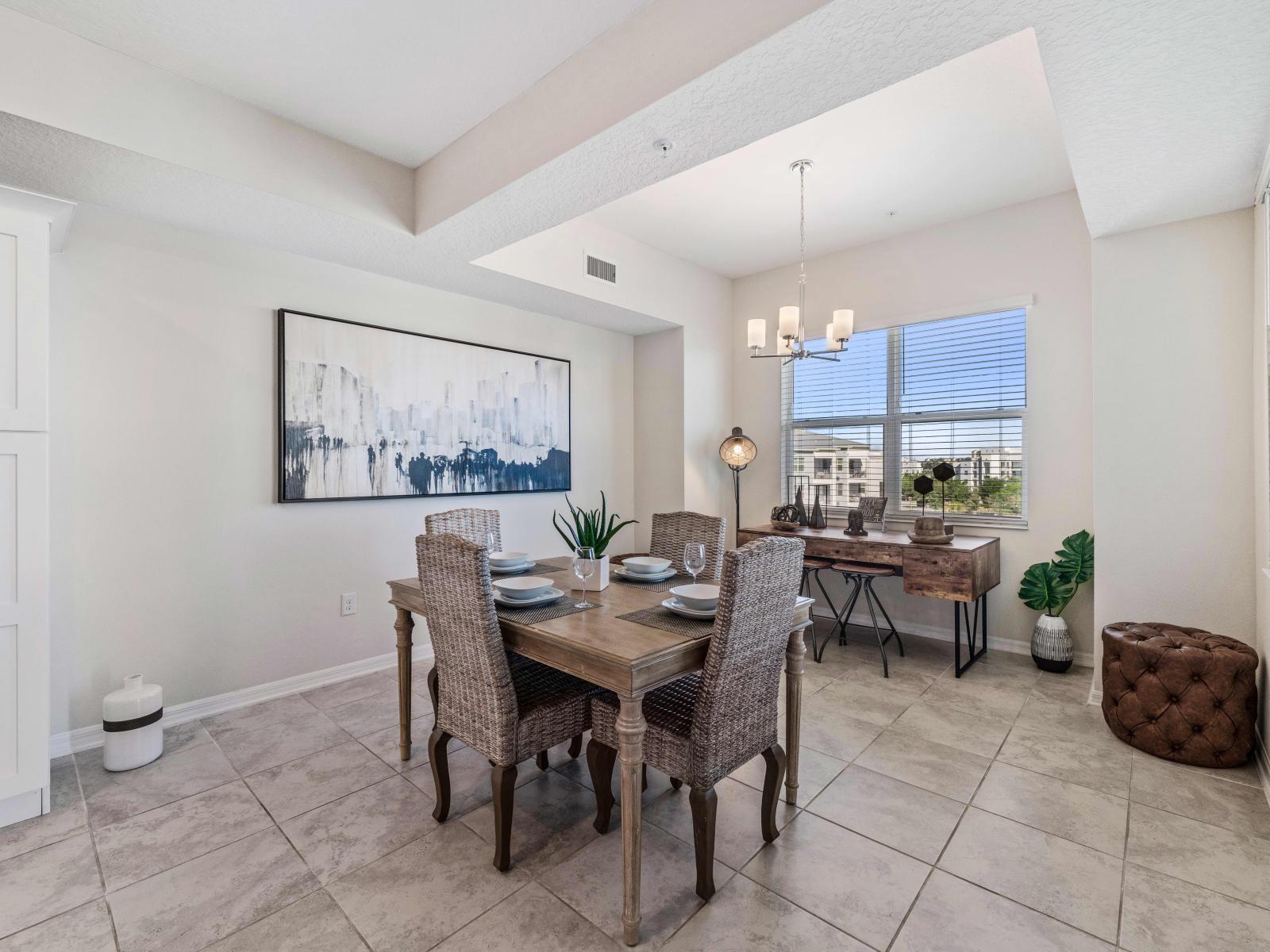 Magnificent Dinning area of the condo in Kissimmee - Stunning 4 Persons Dinning - Spacious dedicated work space - Glorious window with outside views - Aesthetic wall paintings used for the decor - Majestic Chandelier