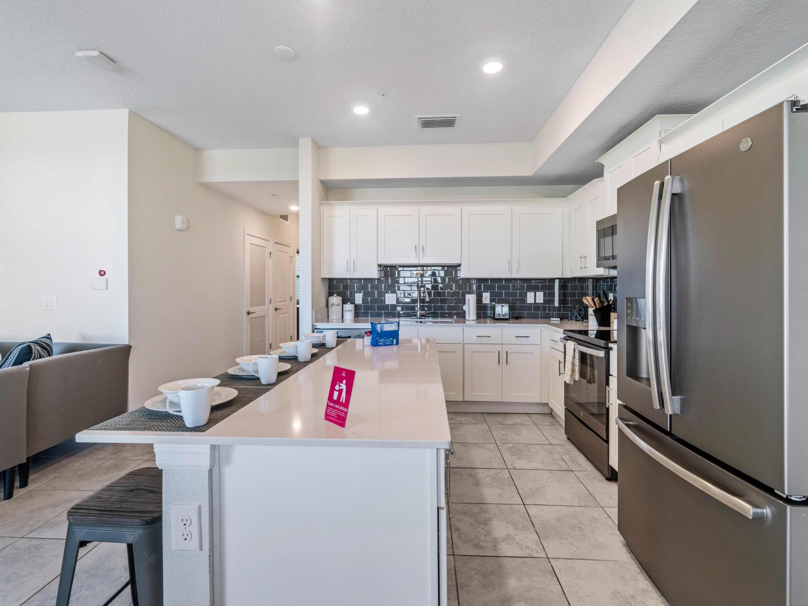 Stunning Fully Equipped Kitchen of the condo in Kissimmee - Availability of all necessary kitchen accessories - High Chairs available at the breakfast ar - Sufficient storage space to store goods - Balcony facing kitchen of the condo