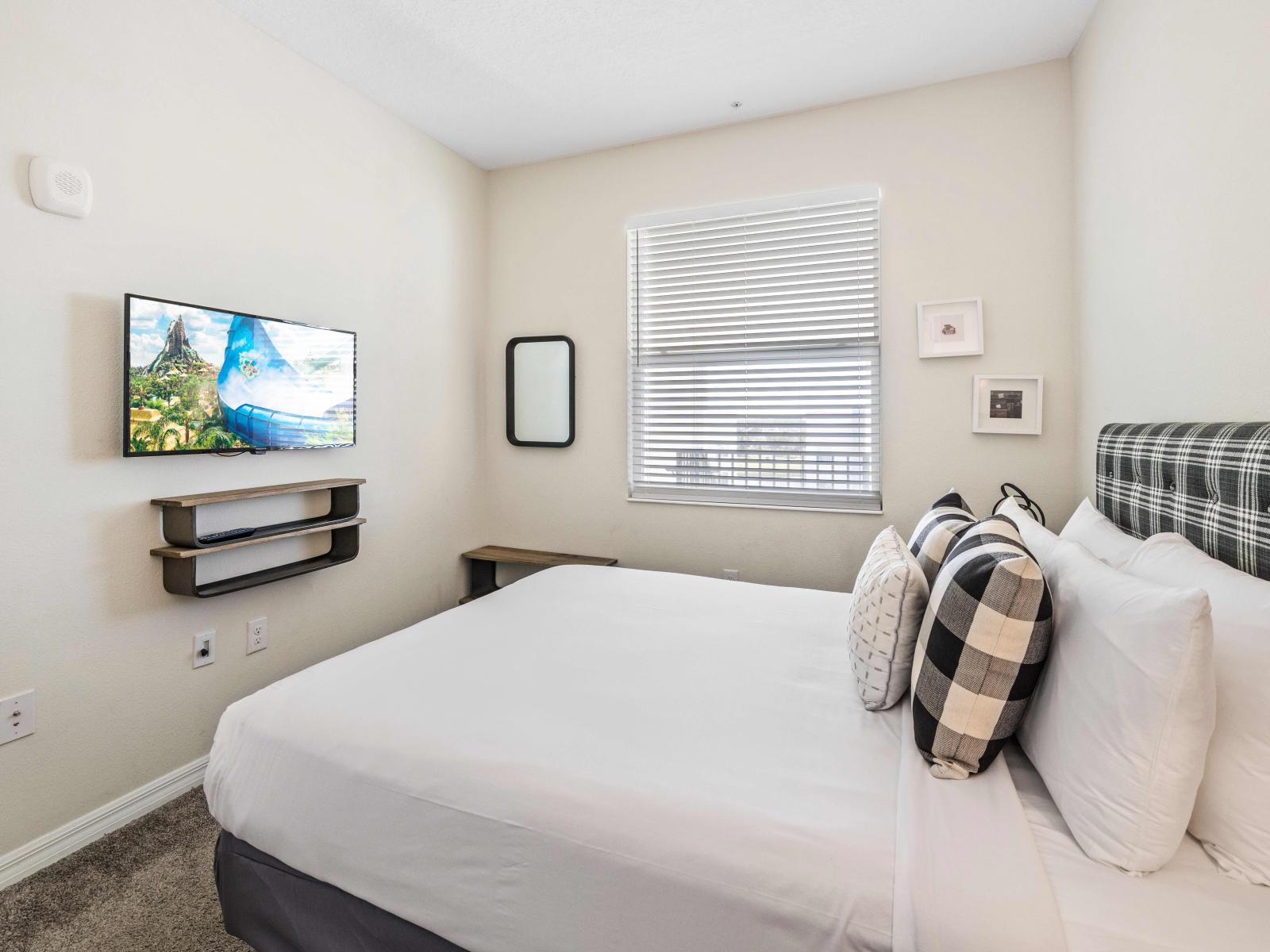 Panoramic bedroom of the condo in Kissimmee - Bed with soft pillows and neat and clean linen - Walls decored with Aesthetic wall paintings - Availability of Tv and Netflix - Thoughtfully located window with beautiful outside views