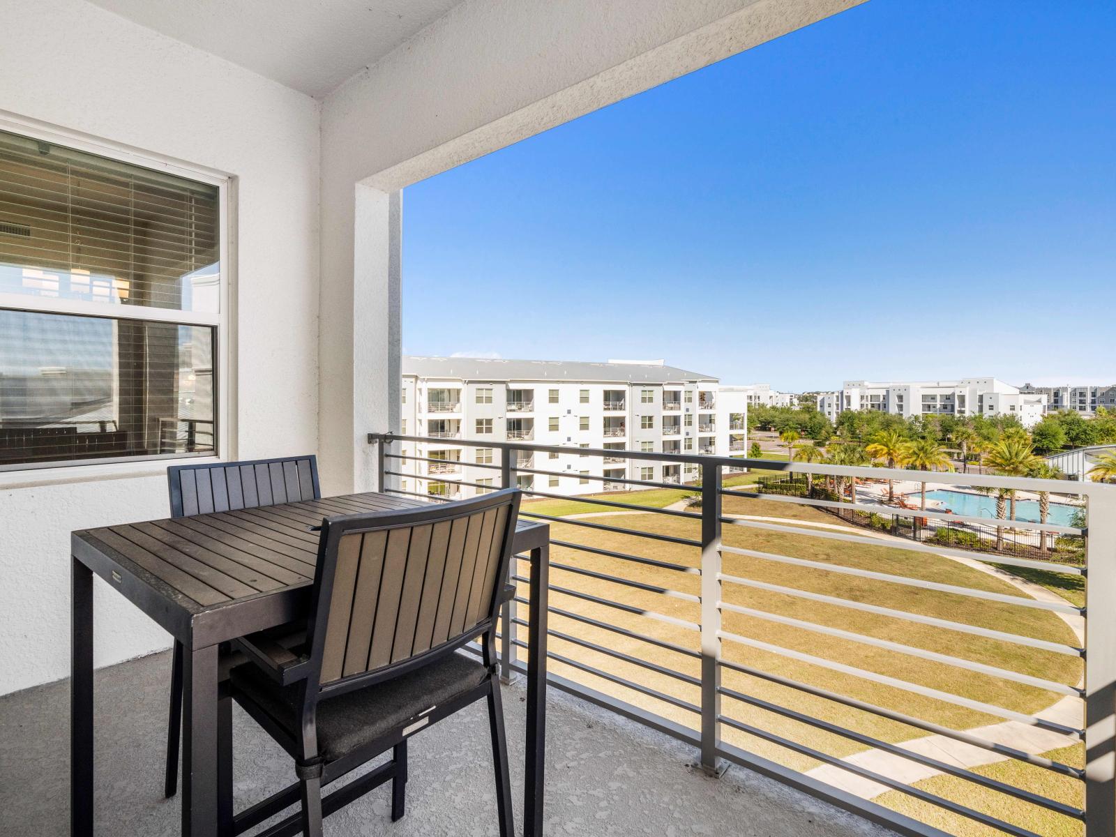 Well-appointed Private Balcony of the Condo in Kissimmee - Pool facing stunning balcony with surrounding views - Beautiful Dinning for having coffee in the refreshing atmosphere - Enjoy the sunshine while sitting in the fresh air at the balcony