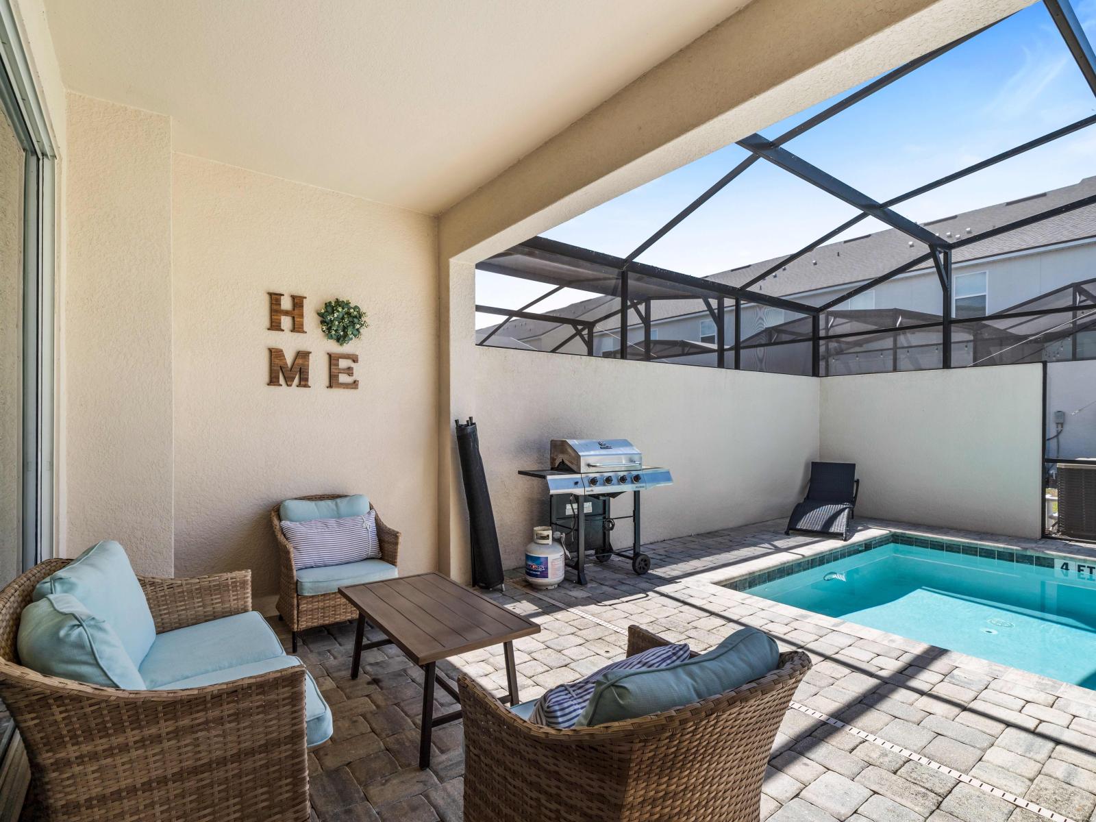 Unwind amidst the picturesque beauty of our outdoor seating area of the home in Kissimmee - Every moment is enhanced by relaxation and a delightful atmosphere by the pool side - Availability of cozy beach chairs and BBQ Grill