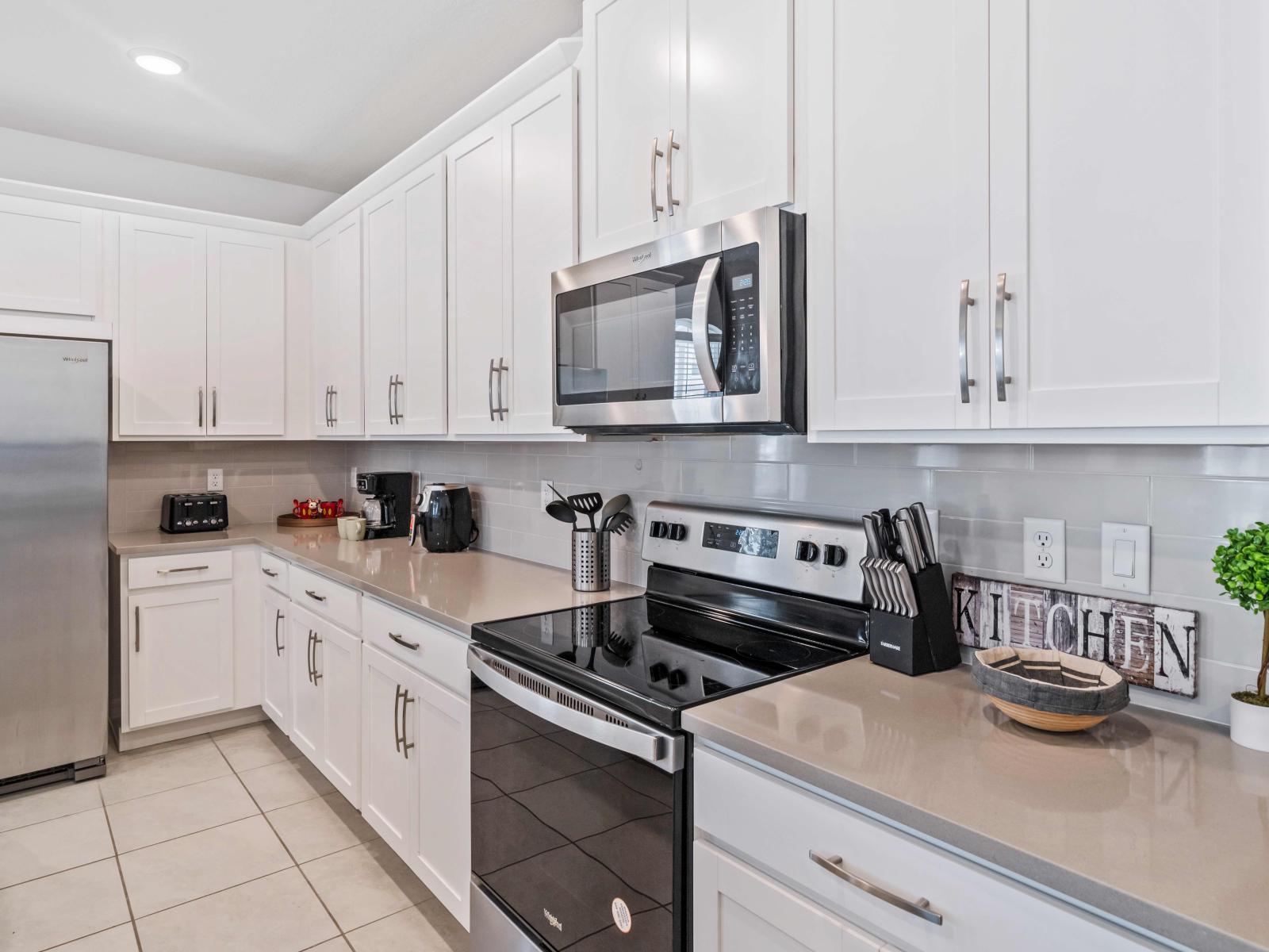 Discover home-cooked bliss in our fully-equipped kitchen of the home in Kissimmee - Our kitchen is stocked with all necessary essentials - Providing a welcoming space for culinary exploration