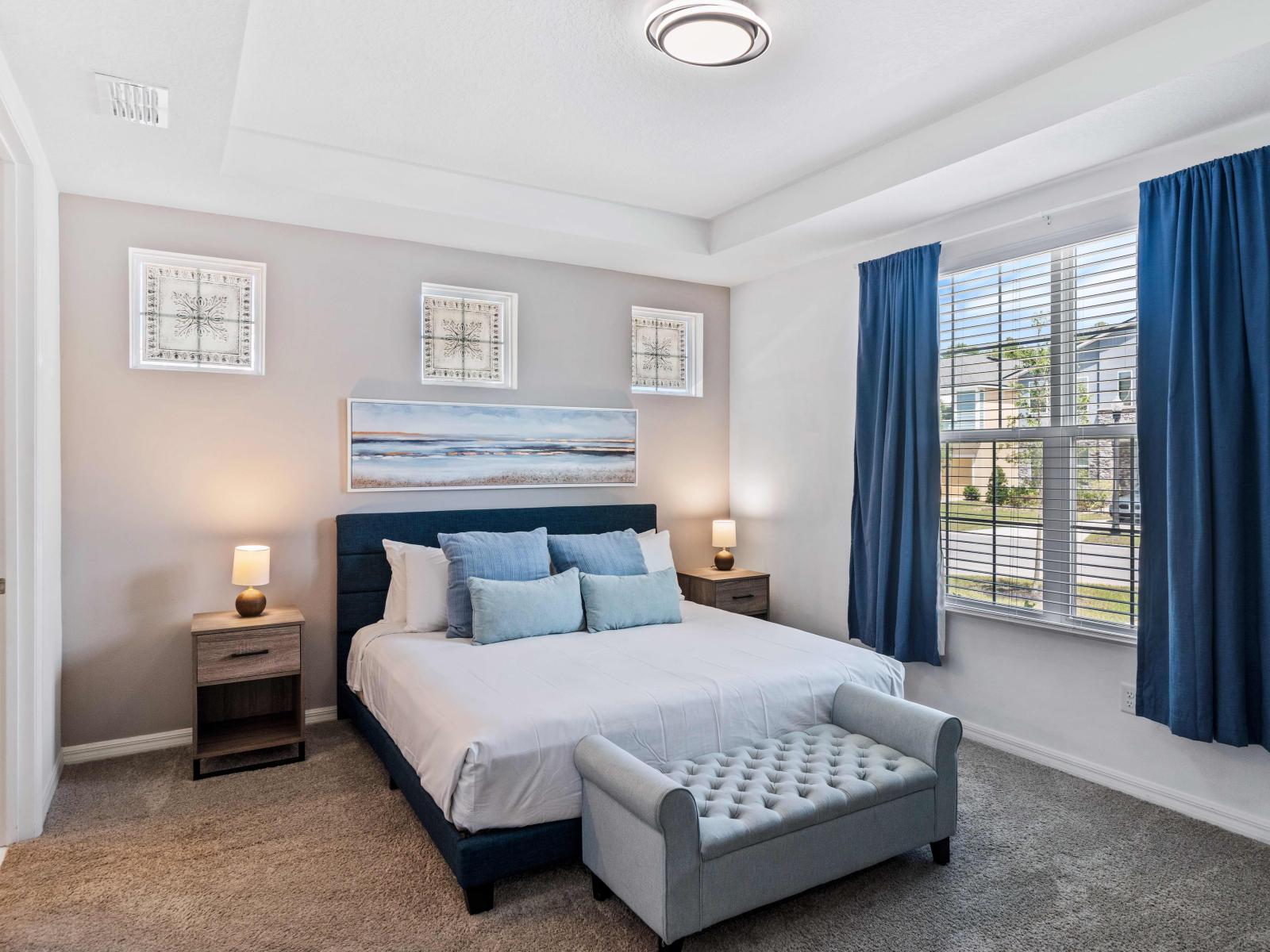 Luxurious bedroom of the home in Kissimmee  - King size cozy bed with neat and clean linen - Glorious outside views for the large windows - Stunningly carpeted floor - Majestic table lamps on the bedside and decored with aesthetic wall painting