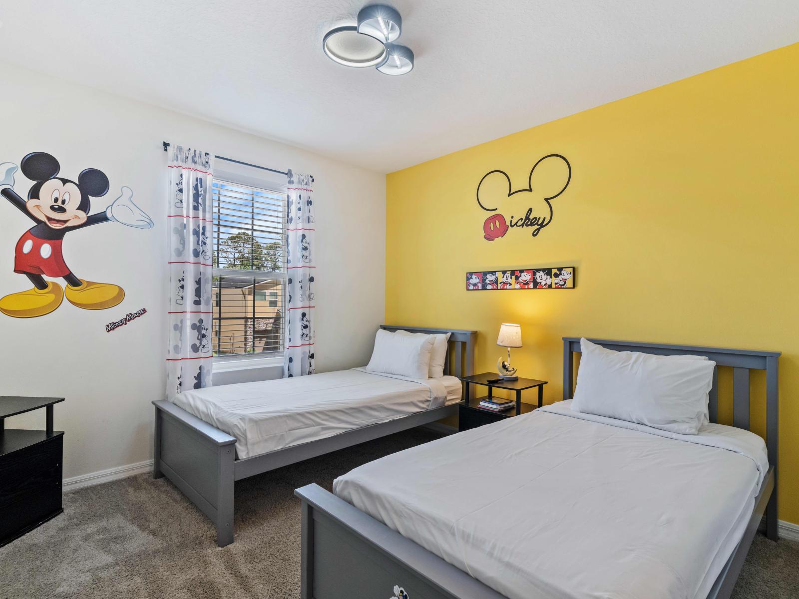 Experience the captivating world of Disney in Mickey Mouse-themed bedroom of the home at Vista Cay Resort - With magical décor it provides 2 single beds to relax - Step into a realm of childhood dreams in the Mickey Mouse-themed bedroom