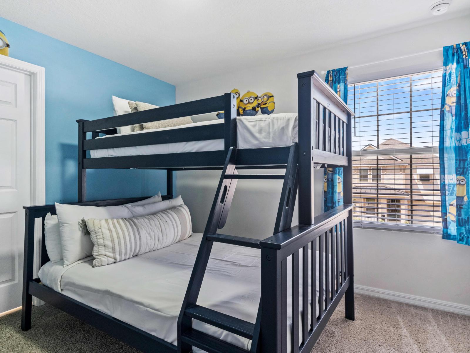 Immerse yourself in the world of Minions with our themed bedroom of the home in Kissimmee - Featuring a double and single bunk bed adorned with playful decorations. - Perfect room for sibling bonding with elegantly carpeted floor