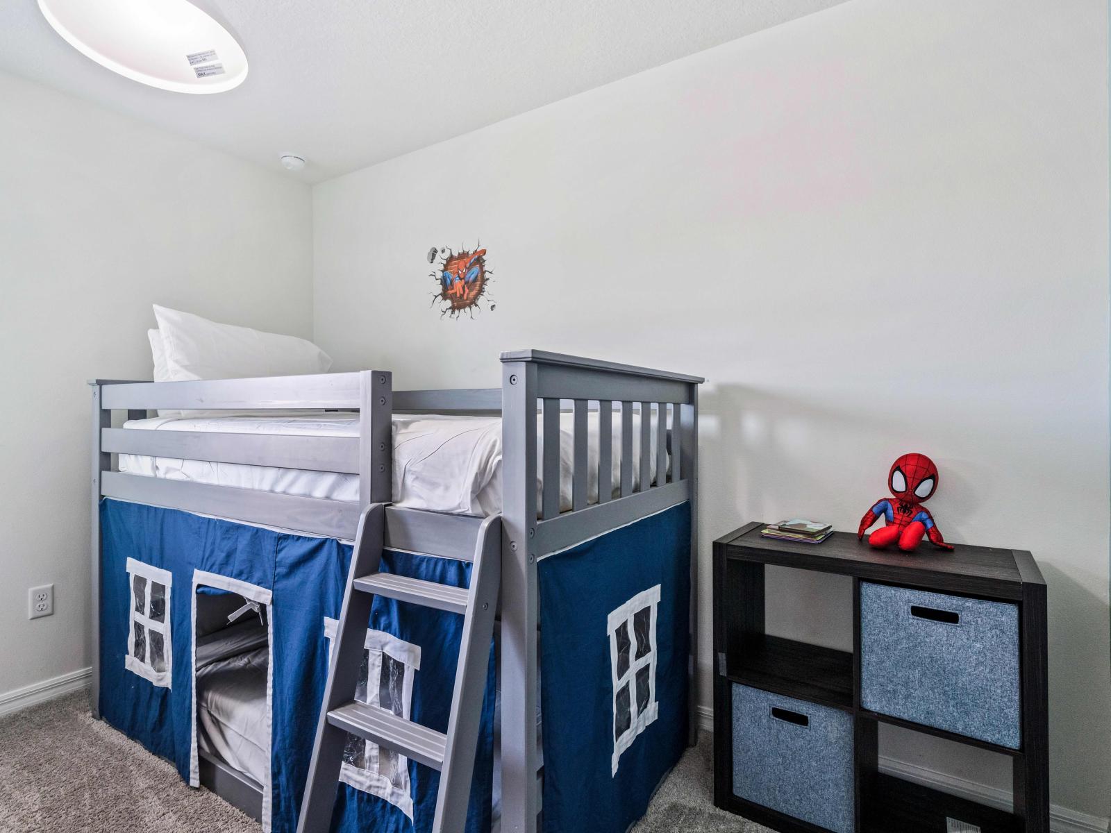 Experience the ultimate kid's haven in our Marvel-themed bedroom in Kissimmee - Enjoy cozy sleepovers with a bunk bed and indulge in thrilling air hockey games - Catering to both fun and relaxation for the little ones.