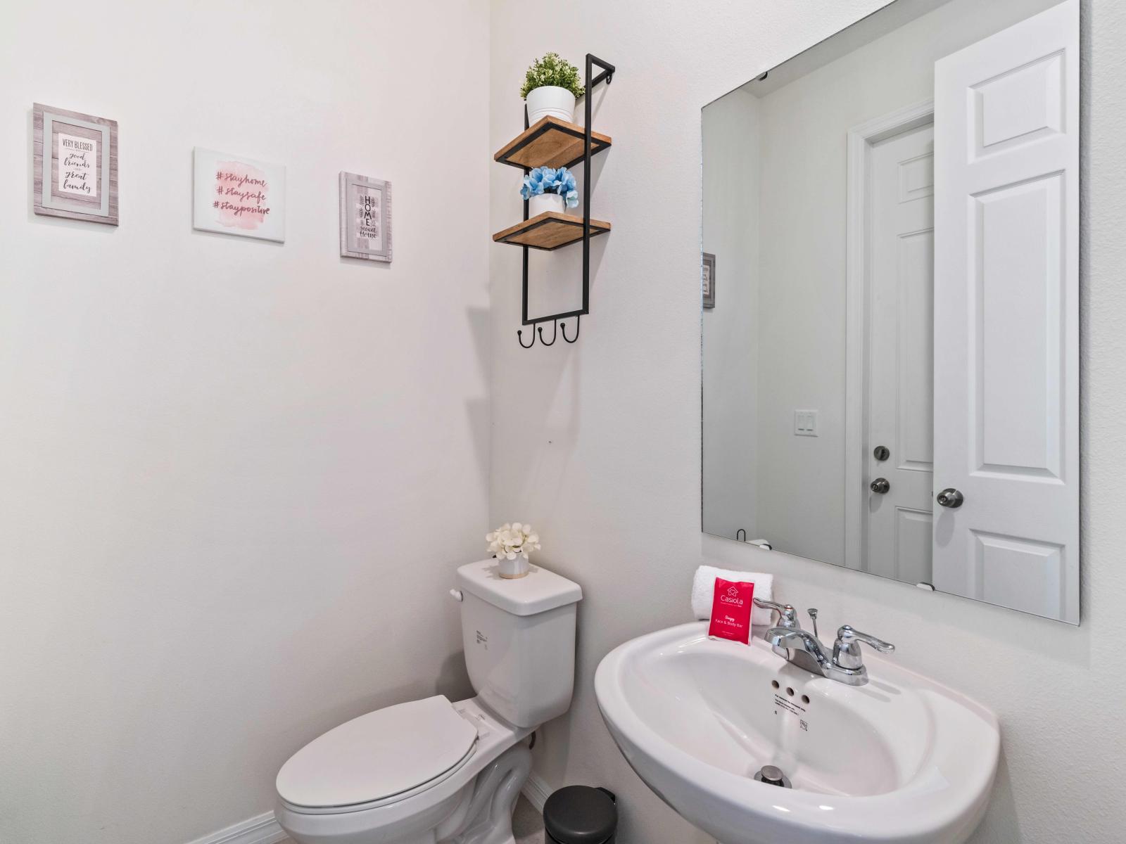 Discover a cozy retreat in our half bathroom of the home in Kissimmee - Offering convenience and comfort in a compact space - Featuring trendy accents and thoughtful design elements - Providing guests with a stylish spot to freshen up