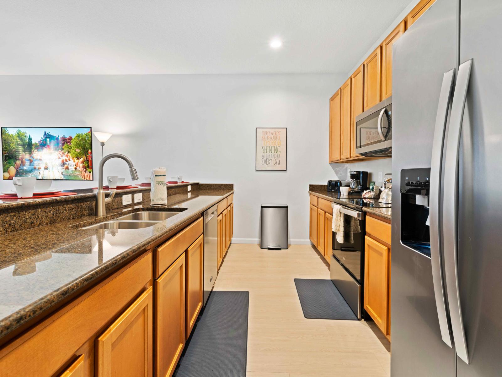 Lofty Kitchen of the Townhouse in Kissimmee Florida - Open concept connecting the kitchen to the dining and living area - Harmony of textures, blending wood, metal, and stone elements