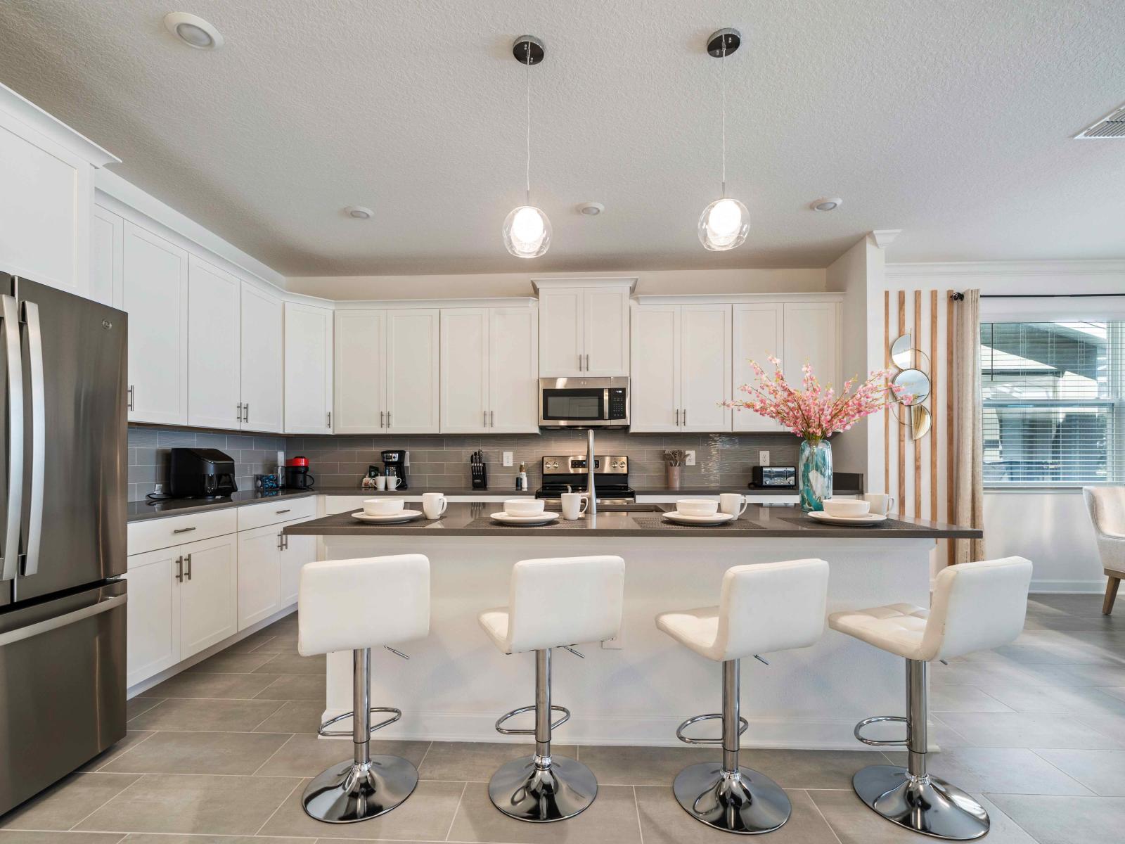 Well-designed kitchen of the home in Davenport - Fully Equipped with all kitchen accessories - Sufficient space to store goods - Plenty space to work according to your ease - High chairs available at the breakfast bar of the kitchen