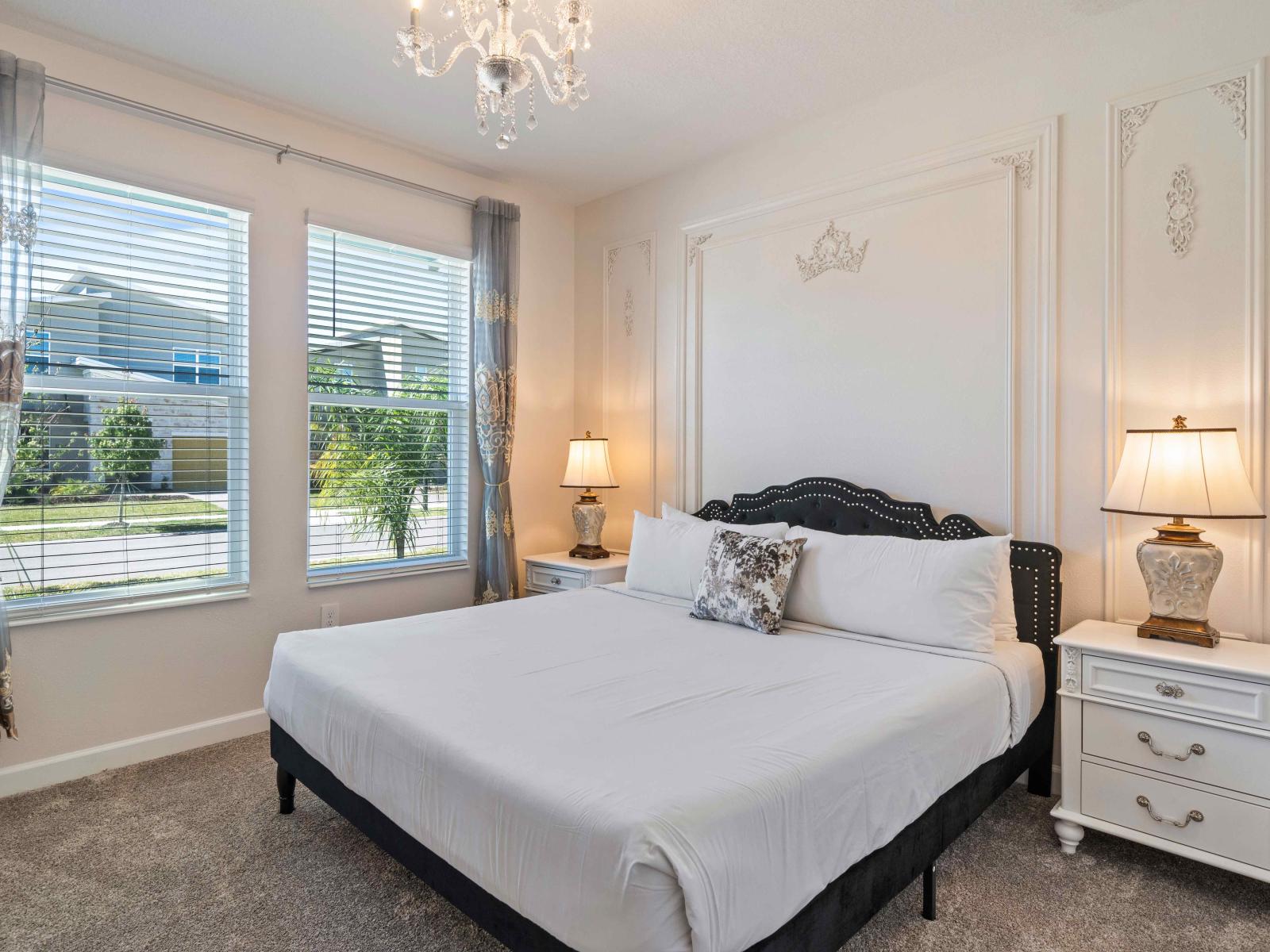 Lavish Bedroom of the home in Davenport - Relaxing king size bed - Stunningly carpeted floor - Majestic table lamps and Eye catching Chandelier - Luxuriously designed walls - Neat and clean linen - Large windows with outside views