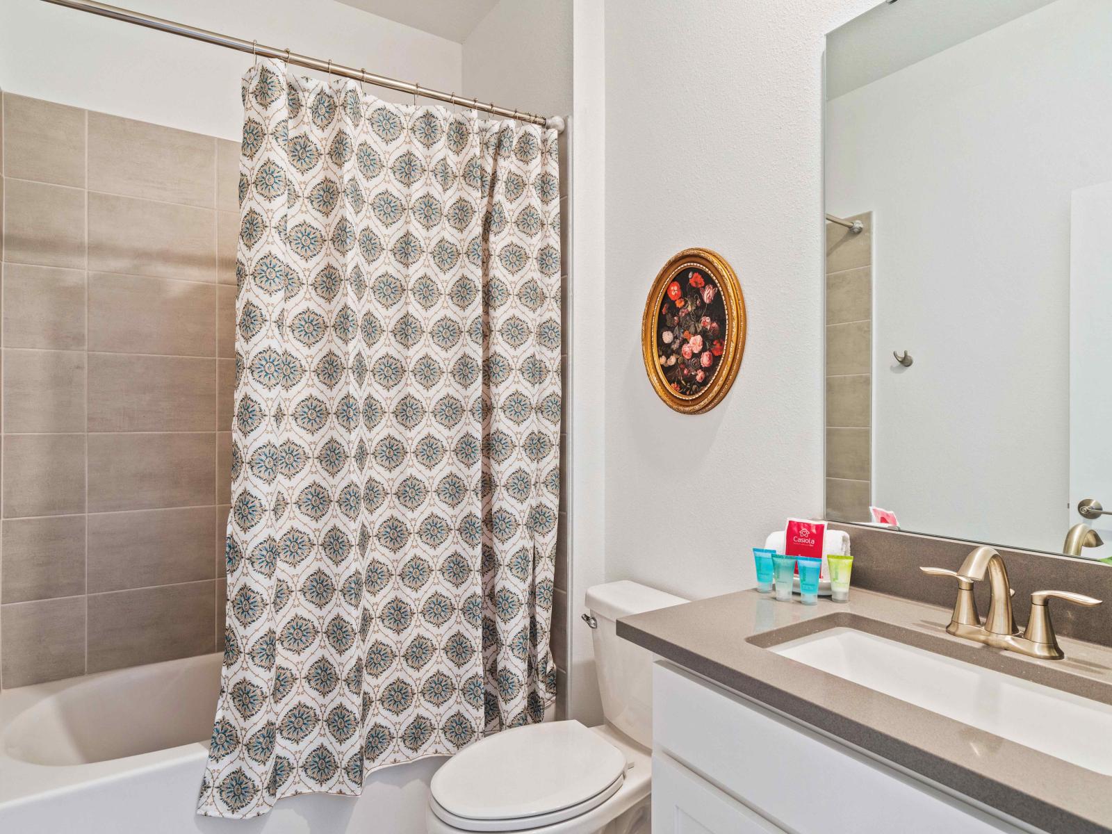 Classical Bathroom of the home in Davenport - Bathtub and a shower combo with a sliding curtain - Glorious vanity with large wall mirror - Neat and clean cozy toilet seat - Complete amenities available