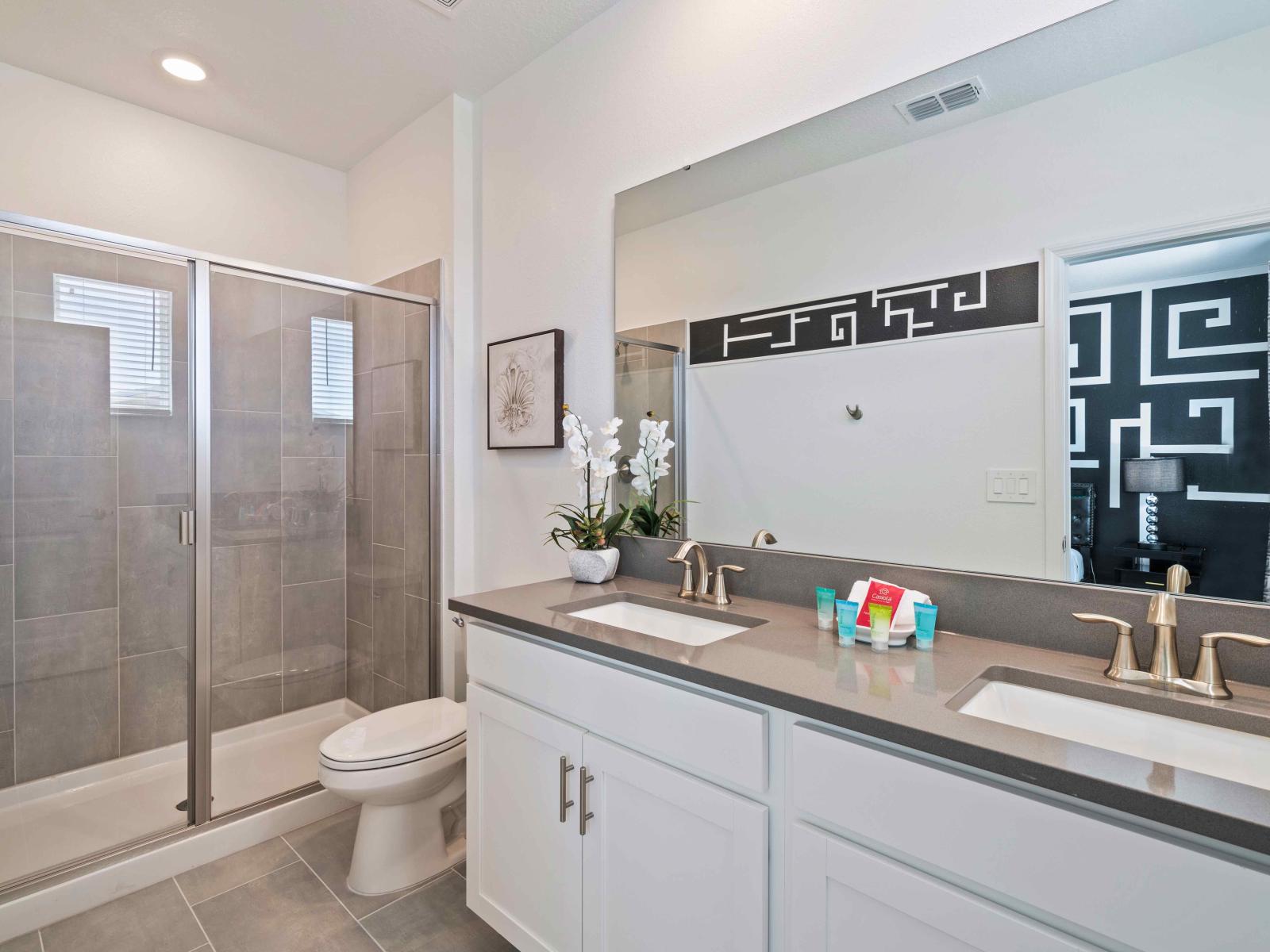 Classy Bathroom of the home in Davenport - Stunning walk-in shower with glass doors - Glorious Vanity with twin sink and large wall mirror - Neat and Clean toilet seat - Sufficient storage space - All bathroom amenities available