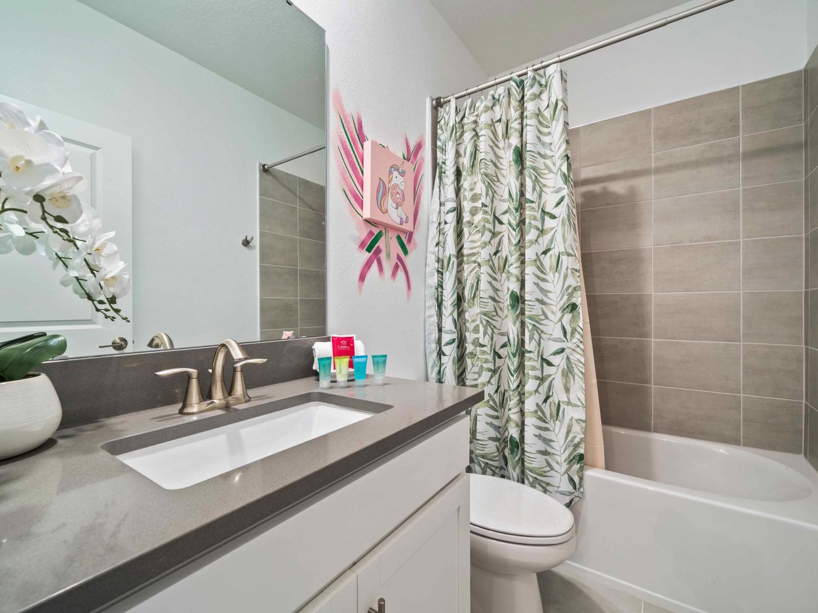 Exclusive Bathroom of the home in Davenport - Cozy bathtub and a shower combination - Neat Toilet seat - Lovely vanity with large size wall mirror - Beautiful wall painting for decor - All necessary bathroom amenities available