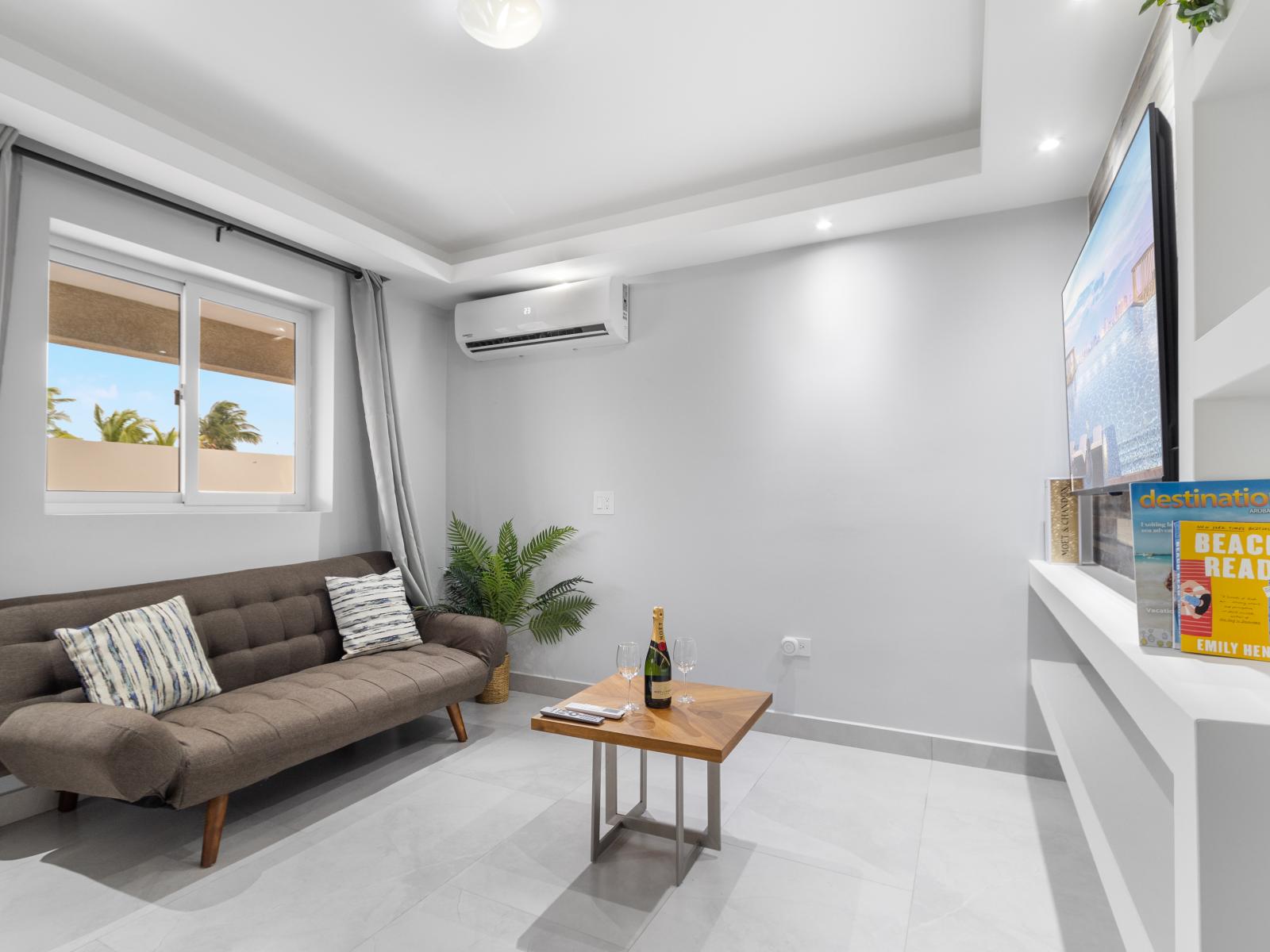 Captivating living area of the apartment in Oranjestad Aruba - Offers a pull out full size sleeper sofa  - Smart TV for endless entertainment - Well-planned layout maximizing comfort and functionality