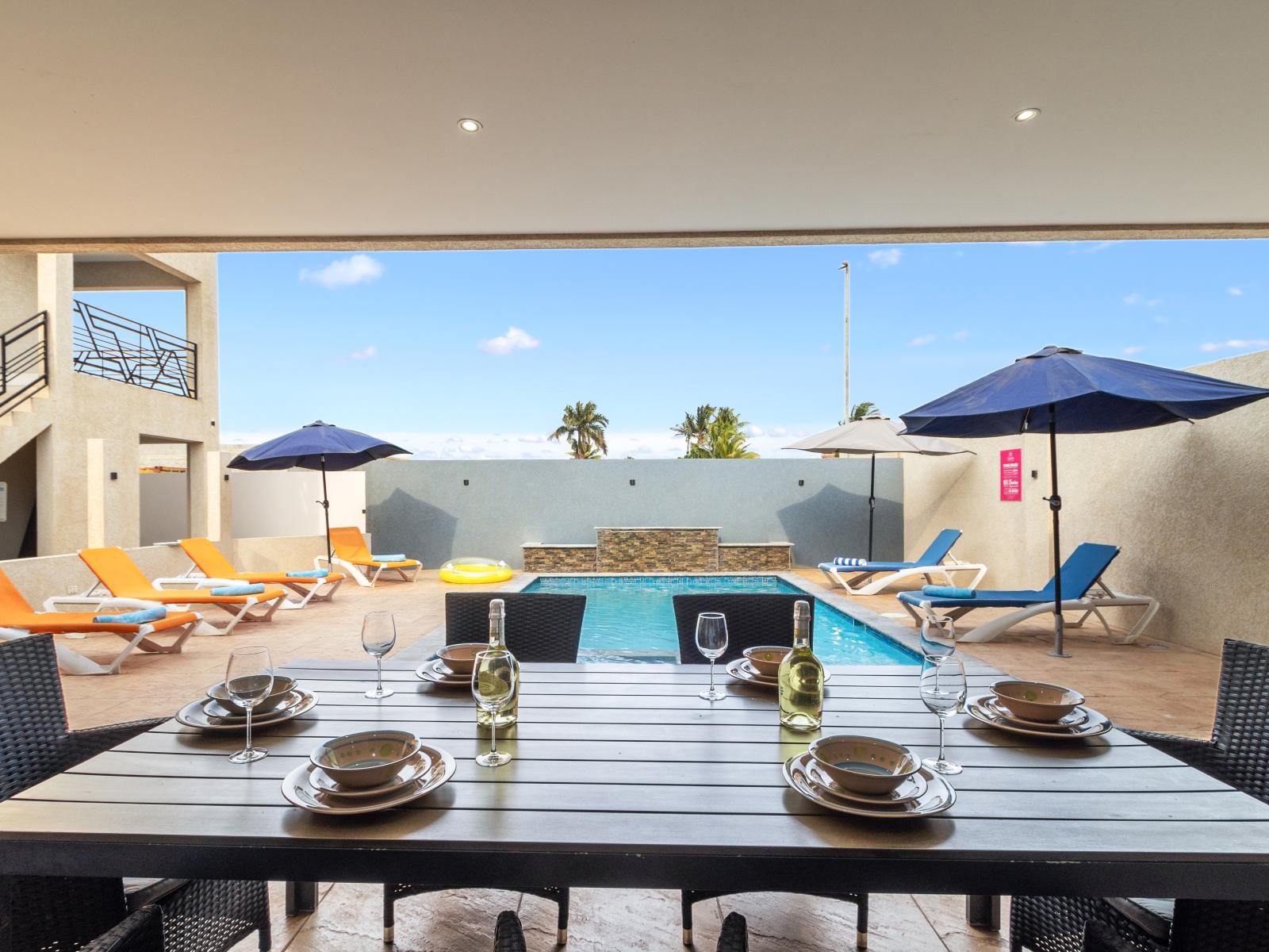 Shared outdoor dining area of the apartment in Oranjestad Aruba - Enjoy meals outside with loved ones - Gather 'round for al fresco feasts! - Share delicious meals with pool views