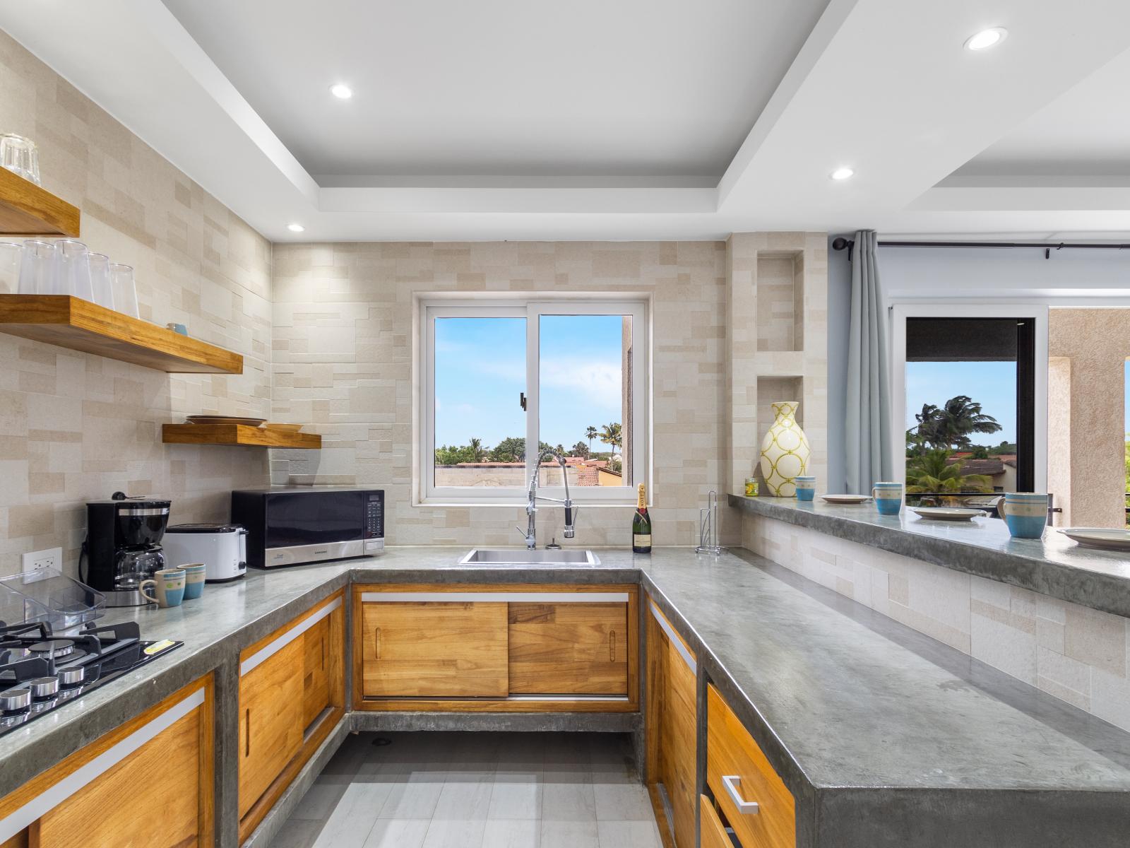 Inviting kitchen of the apartment in Oranjestad Aruba - Sleek stainless steel appliances - Elegant and coordinated color palette for a cohesive look