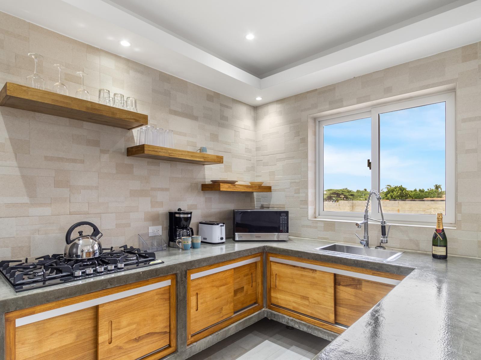 Imposing kitchen of the apartment in Oranjestad Aruba - Fully equipped - Thoughtful placement of kitchen essentials for easy access - Open concept connecting the kitchen to the dining area