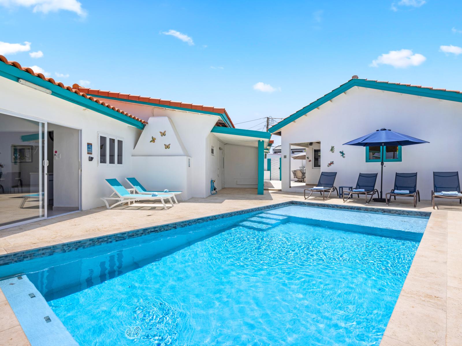 - Refreshing outdoor private pool surrounded by a spacious deck, perfect for lounging under the sun - Cozy sunbeds and an umbrella offer shaded relaxation on warm, sunny days - Open design of the villa blends indoor and outdoor living seamlessly