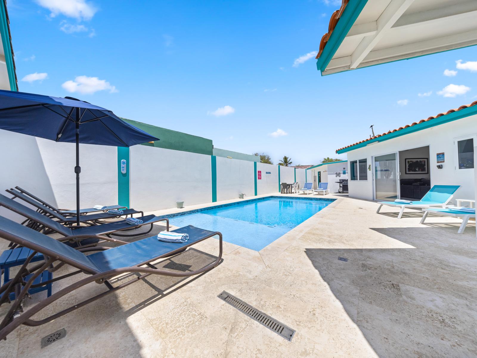 - Spacious private pool area with sun loungers, perfect for relaxing under the sun - Family-friendly environment, ideal for kids to enjoy a refreshing swim - Convenient outdoor seating area, making it easy to transition from poolside to dining