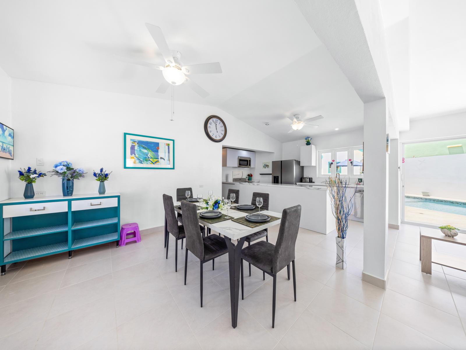 - Dine in style with a modern dining area featuring sleek furniture and contemporary decor - Open floor plan connects the dining room seamlessly with the kitchen and living spaces, ideal for entertaining - Abundant natural light enhances the ambiance