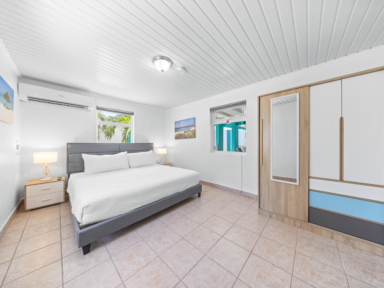 - Spacious bedroom with a plush king-size bed and contemporary decor for a restful night's sleep - Natural light floods the room, creating a bright and welcoming atmosphere - Modern wardrobe offers plenty of storage space for all your belongings