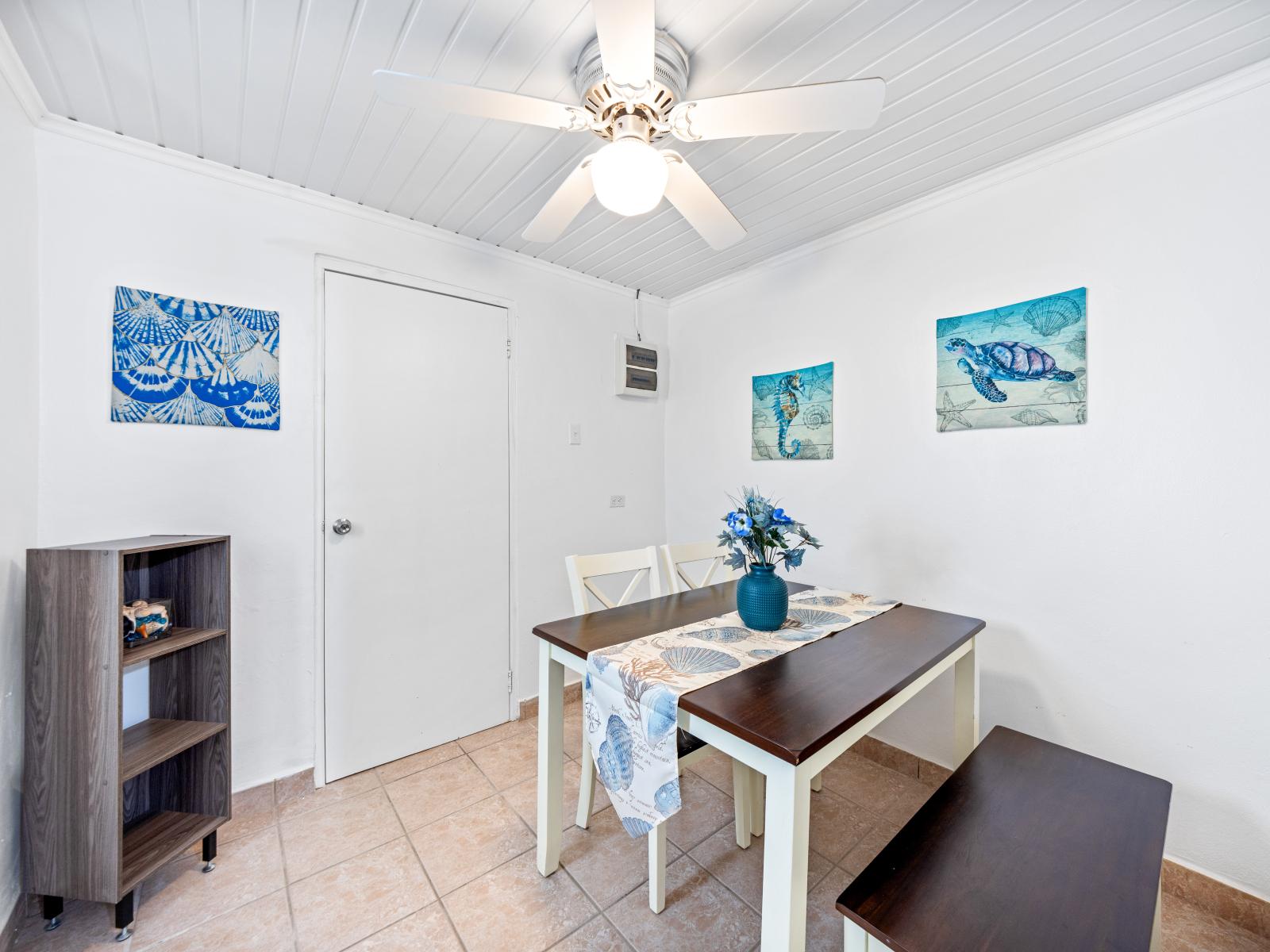 - Enjoy intimate meals in a cozy dining nook adorned with delightful nautical decor - Stay cool and comfortable with a ceiling fan in this bright space - Effortlessly serve meals with the dining area conveniently located next to the kitchen