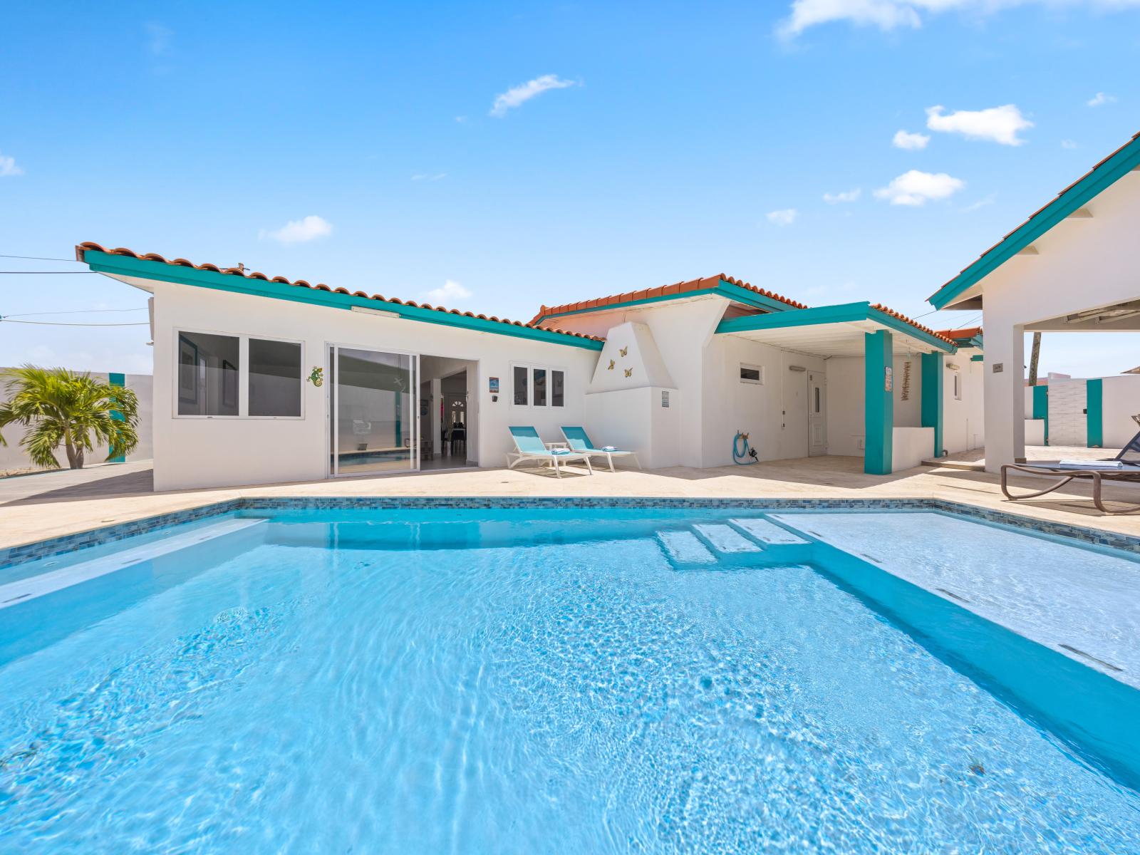 - Dive into the crystal-clear pool, perfect for refreshing swims under the sunny skies - Relax on comfortable loungers, soaking up the sun in your backyard oasis - Enjoy seamless indoor-outdoor living with easy access from the pool to the living area