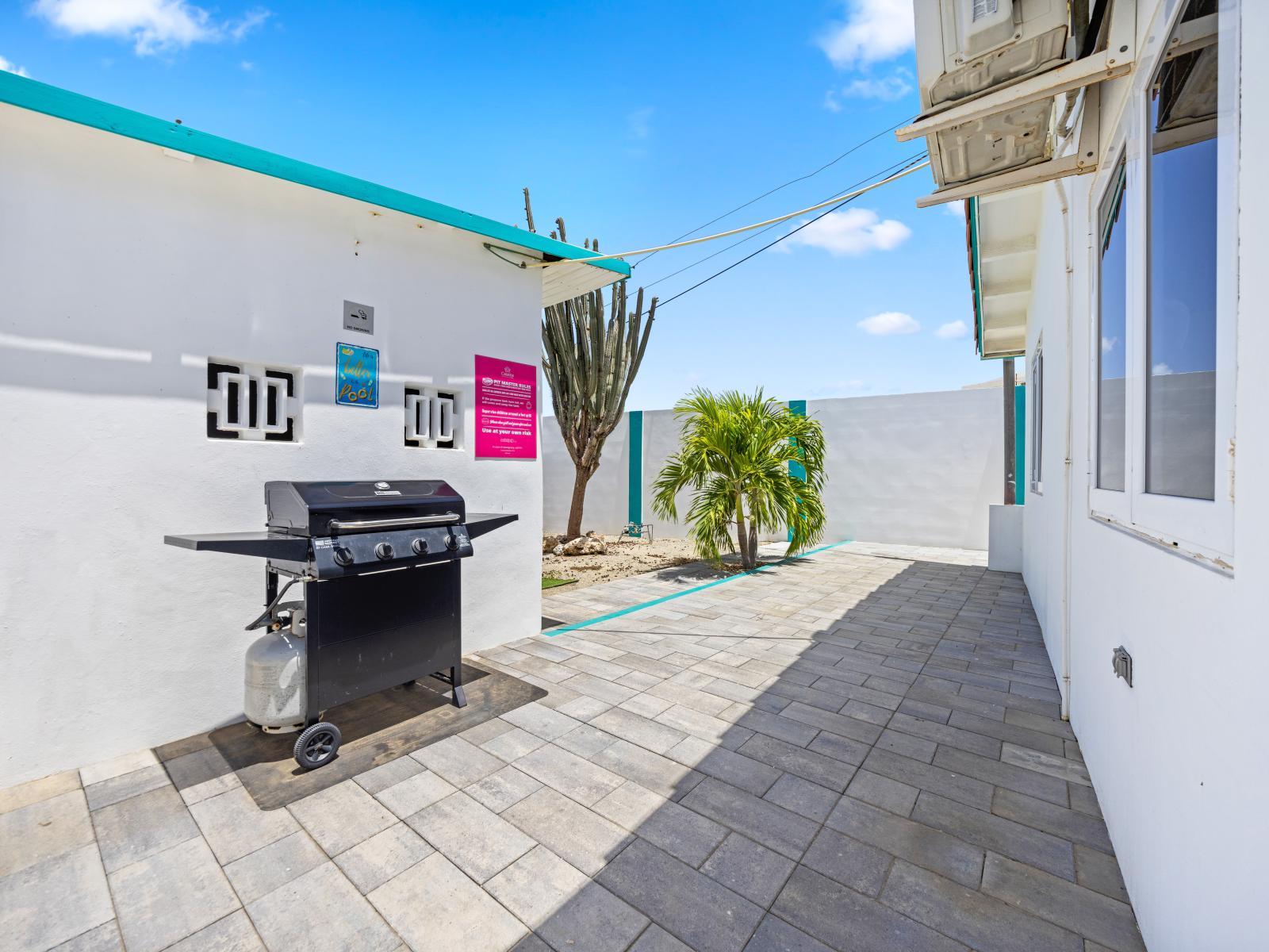 - Fire up the grill for a perfect BBQ experience in your outdoor space - Enjoy the convenience of a spacious, well-maintained area for alfresco dining - Surrounded by vibrant plants, this backyard spot is ideal for outdoor cooking and relaxation