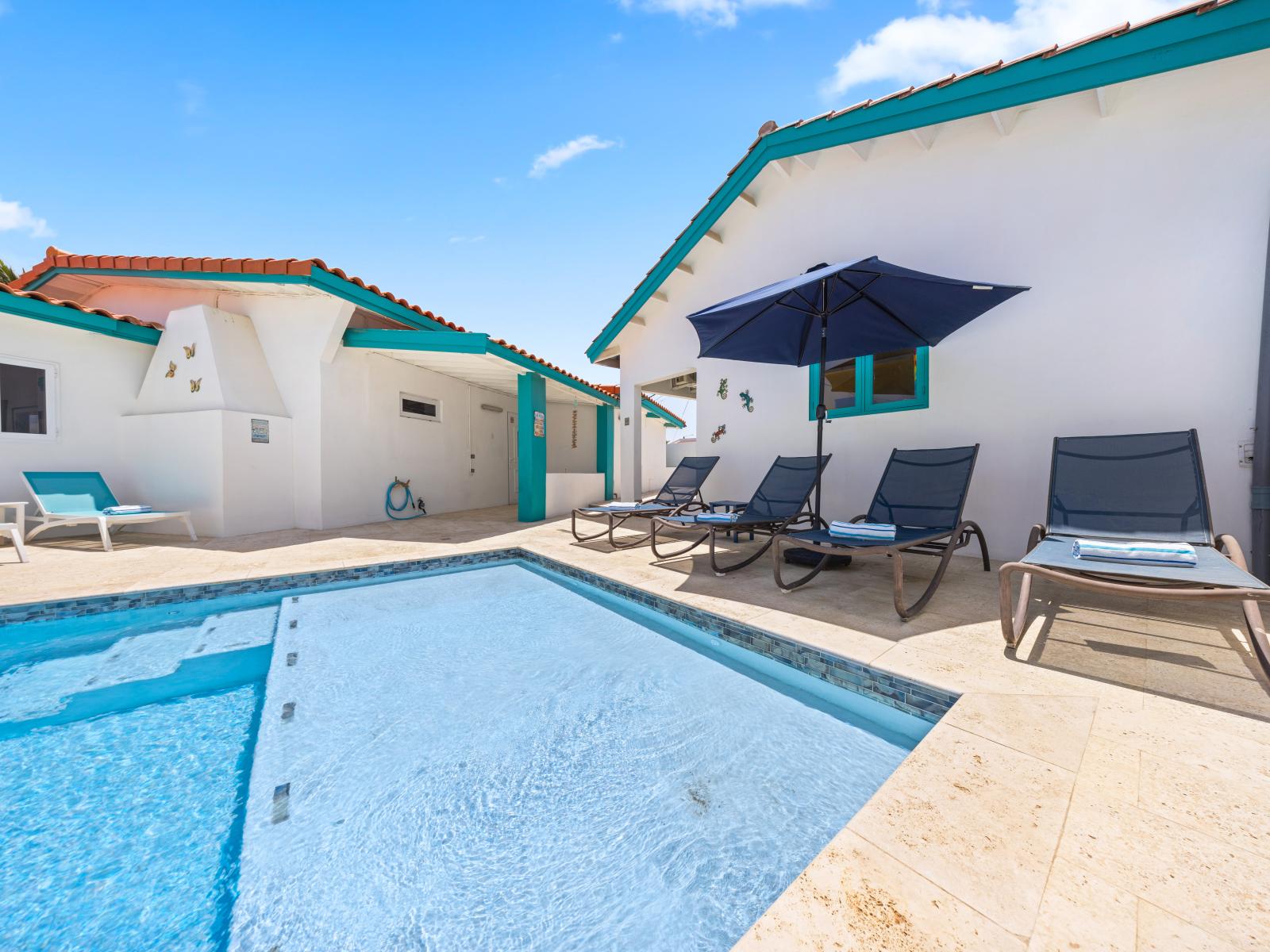 - Lounge by the poolside, soaking in the sun or relaxing under the shade of the umbrella - Perfect for a refreshing dip, the pool invites you to enjoy your vacation - Serene outdoor space offers a slice of paradise, ideal for both relaxation and fun