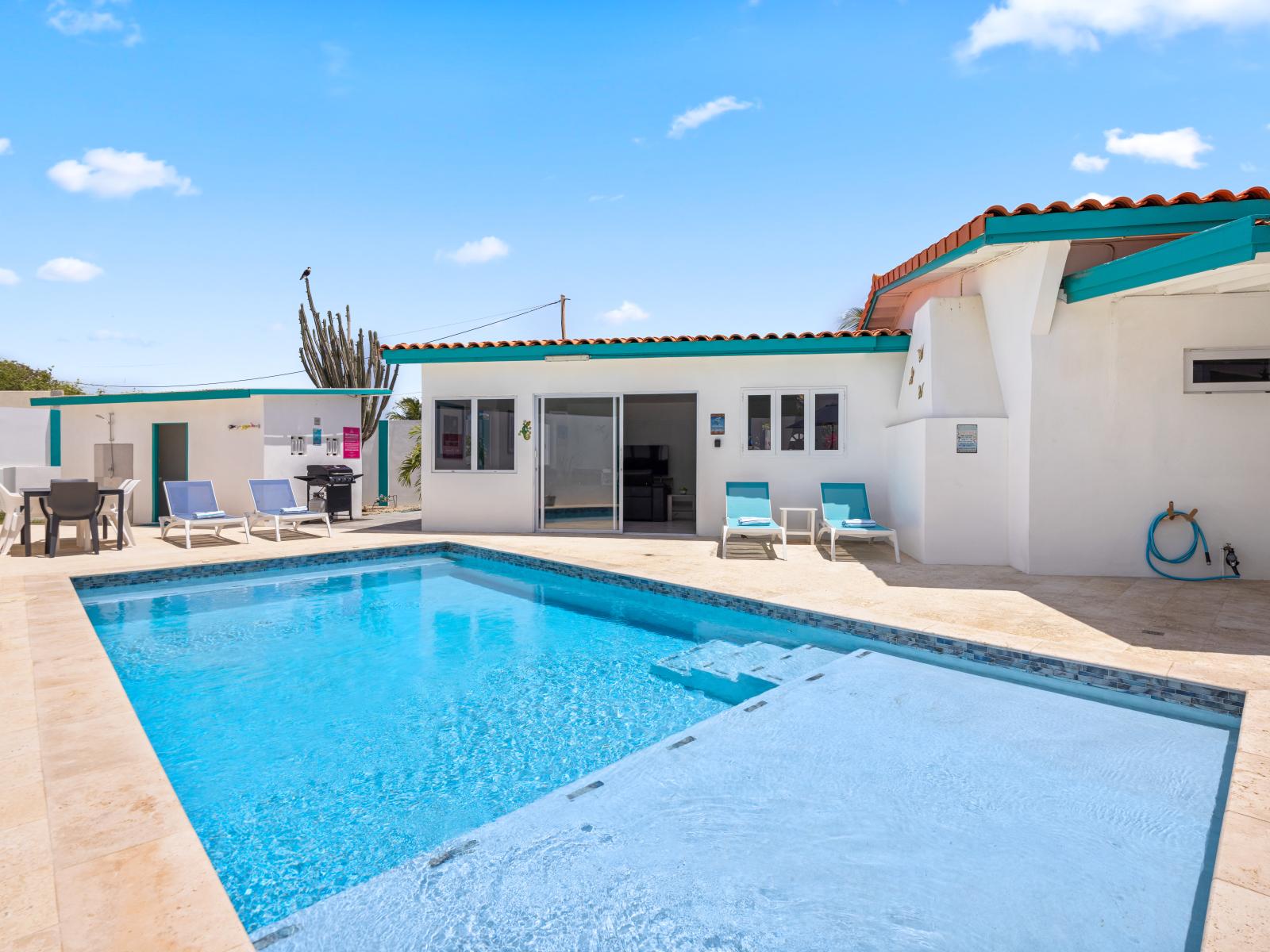 - Dive into the sparkling pool, perfect for a refreshing swim under the sun - Multiple lounge areas around the pool offer plenty of space to soak up the sun or relax in the shade - The shallow end provides a safe space for children to enjoy