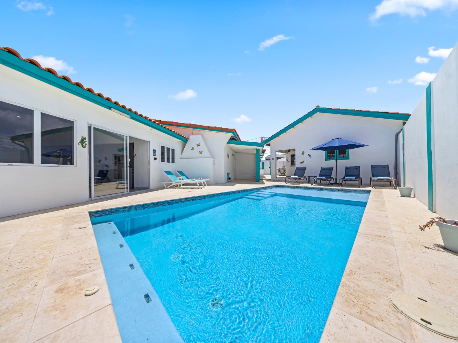 - Dive into the refreshing pool, perfect for a relaxing day under the sun - Lounge by the water on comfortable sunbeds, soaking in the warm weather - This backyard oasis offers a blend of fun and tranquility, ideal for families and friends to enjoy