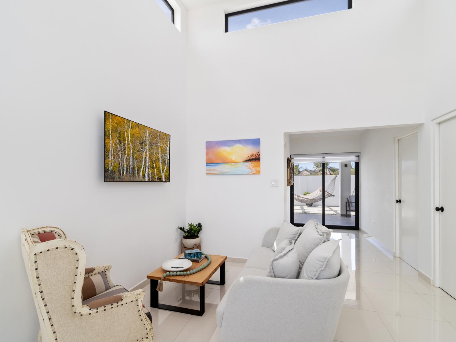 Bright living area of the home in Oranjested Aruba - A space where comfort meets style - Cozy seating area conducive to relaxation and socializing - Smart TV for entertainment