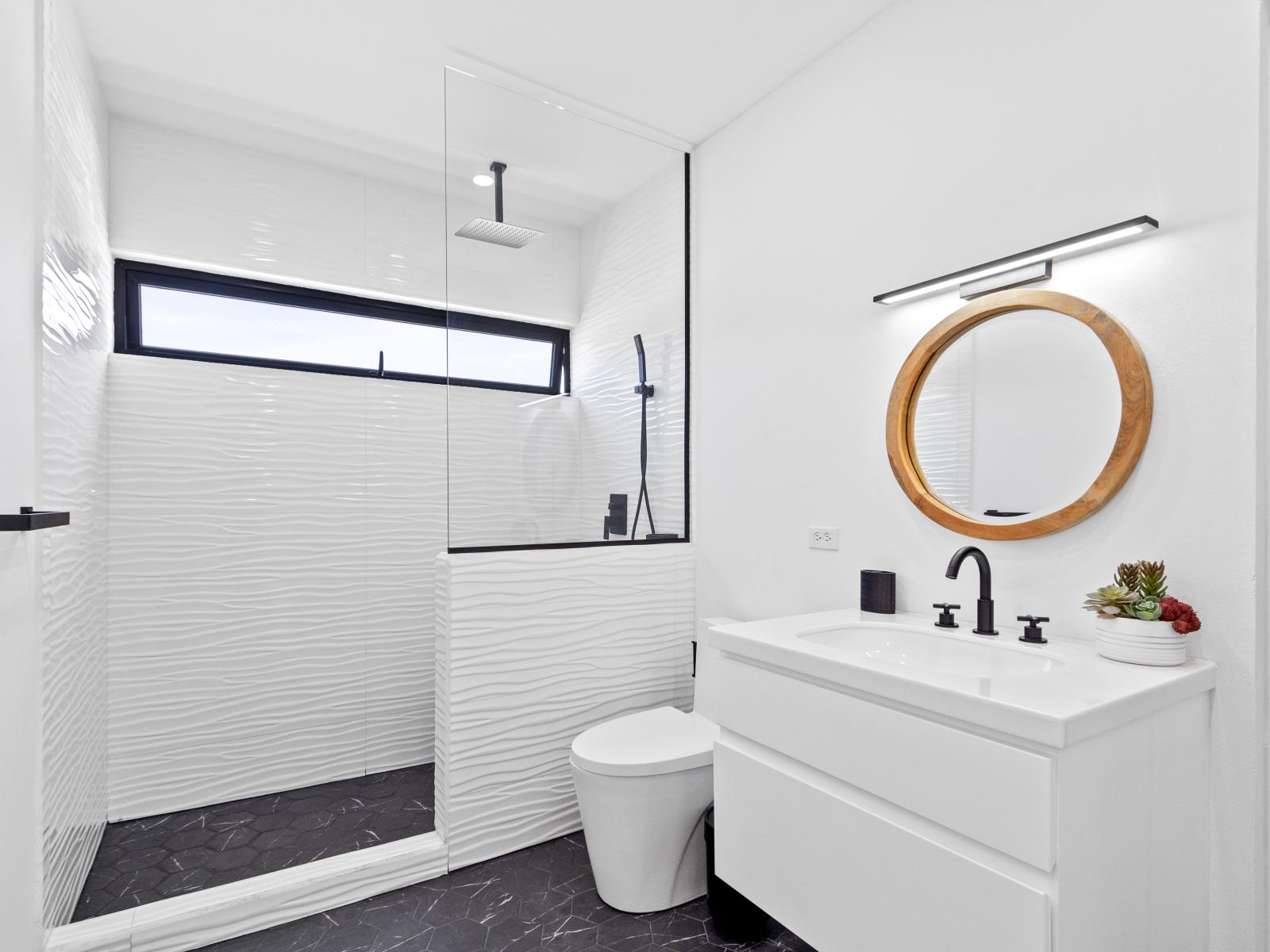 Lovely bathroom of the home in Oranjestad Aruba - Neat and clean toilet seat - Great lighting - Spacious layout offering a sense of luxury and comfort