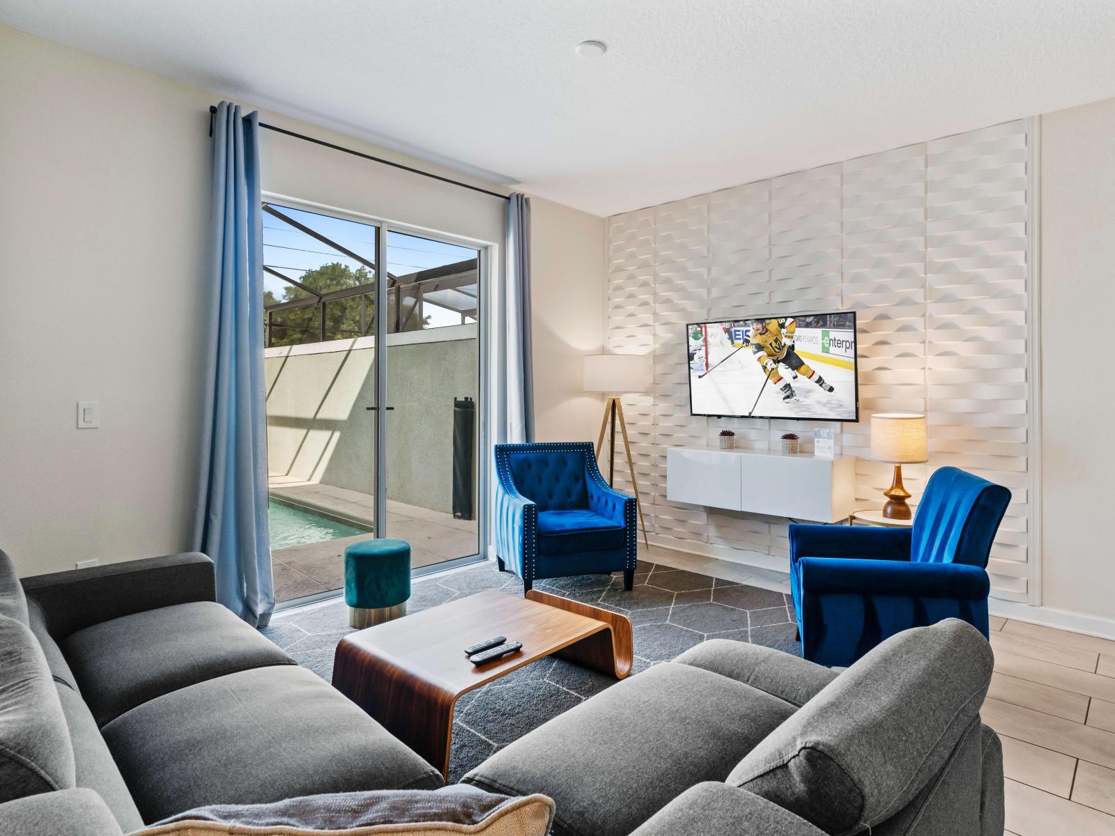 Cozy living area of the townhouse in Kissimmee Florida - Thoughtful mix of textures, from plush rugs to tasteful throw pillows - Smart TV for entertainment - Harmonious color scheme with pops of accent colors for visual interest