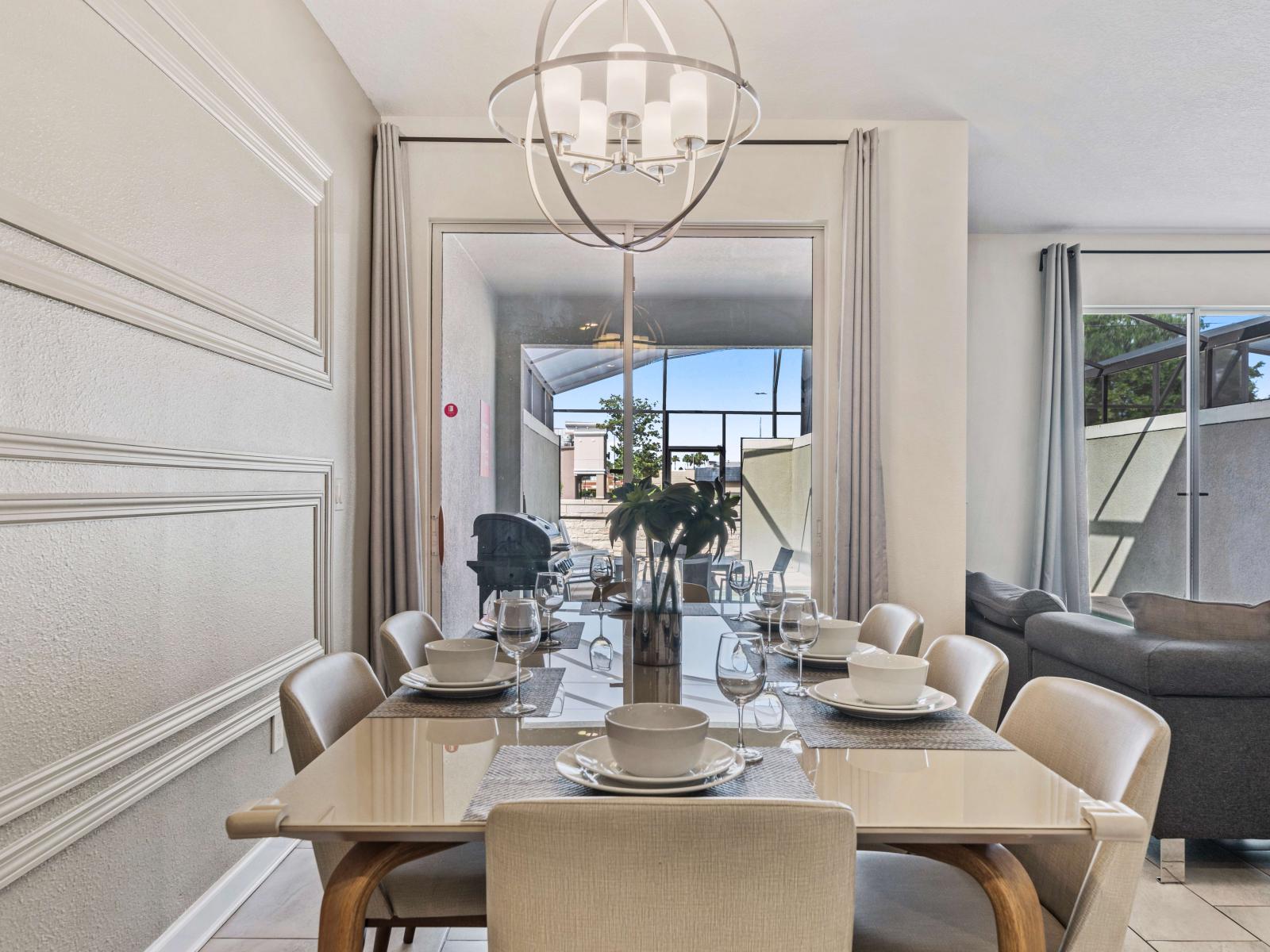 Chic dining area of the townhouse in Kissimmee Florida - Featuring a stylish table and seating for 8 persons - Functional and aesthetically pleasing space - Beautiful lighting fixtures