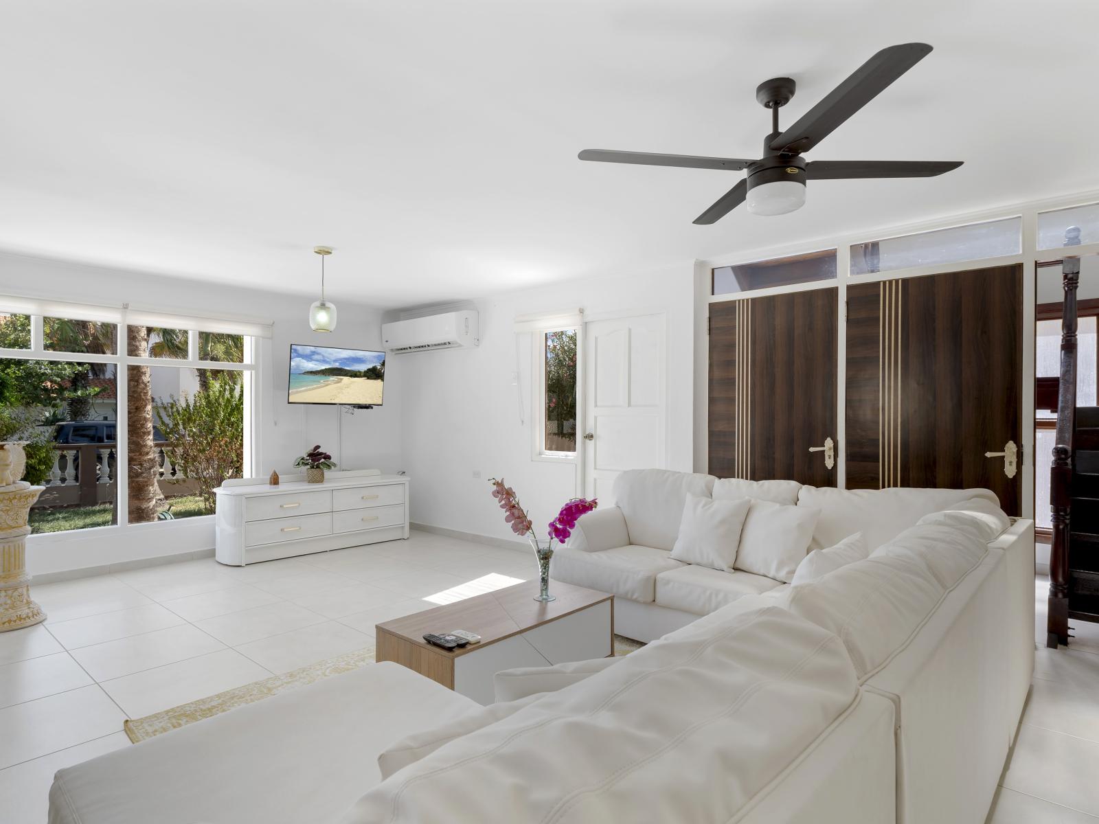 Unwind in style in our spacious and inviting living area of the home in Noord Aruba - Designed for relaxation offering comfortable L shape sofa and a smart TV - Open-concept living area seamlessly connected to a stylish dining space