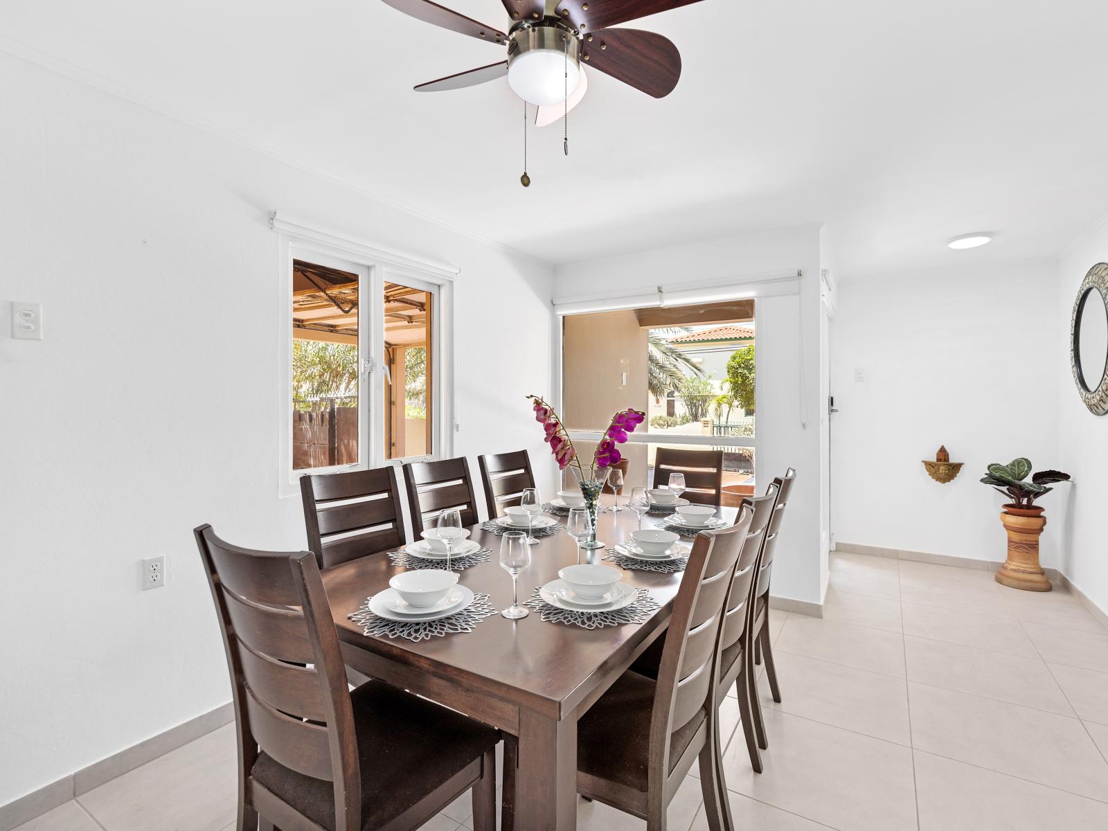 Elevate your dining experience in comfortable dining area of the home in Noord Aruba - 8 persons dining area featuring a stylish table and contemporary seating - Harmonious color scheme for a cohesive and stylish look