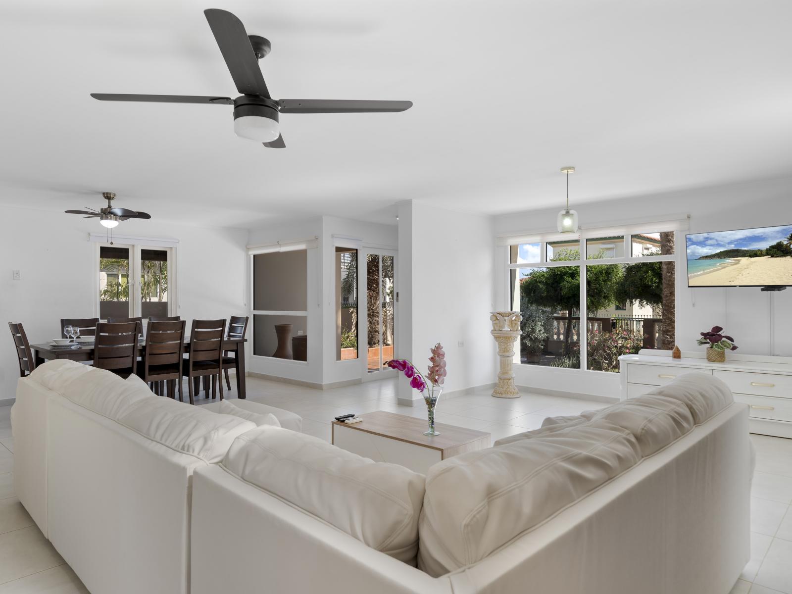 Discover the joys of gathering with friends and family in spacious living area of the home in Noord Aruba - Balance of sophistication and comfort, featuring elegant yet inviting furniture - Modern decor and sleek design elements for a chic ambiance