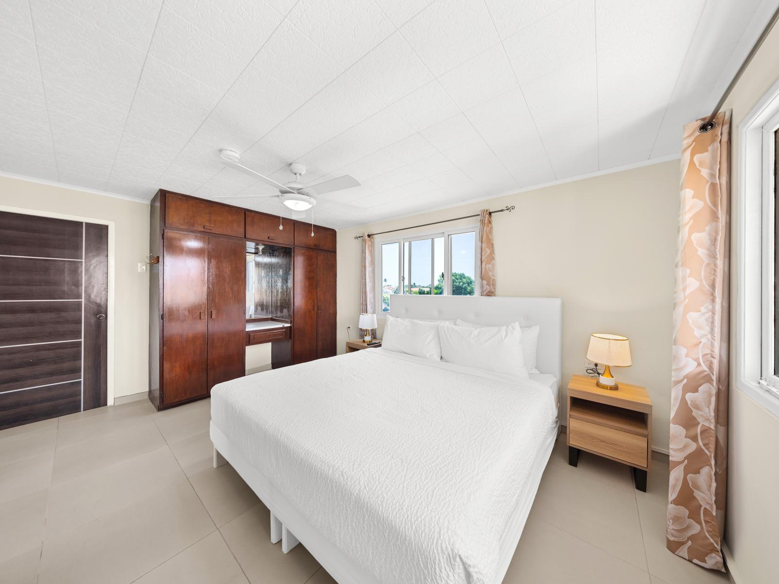 Cozy up and feel right at home in charming bedroom of the home in Noord Aruba - Relax and unwind in king size bed the perfect retreat after a day of adventure - Well-appointed bedroom with neutral tones for a calming atmosphere