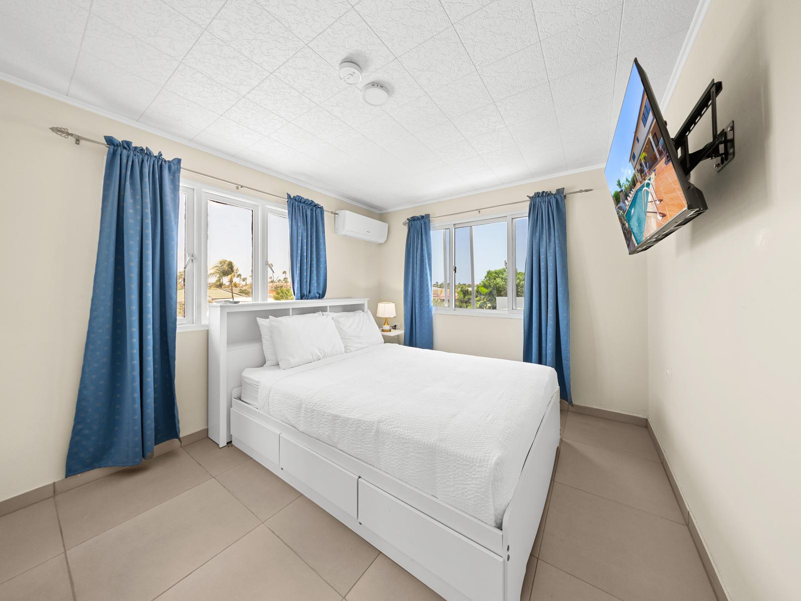 Experience blissful slumber in beautifully appointed bedroom on second floor of the home in Noord Aruba - Plush furnishings, smart TV and sumptuous bedding for comfort - Find your sanctuary in calming space, where comfort meets sophistication